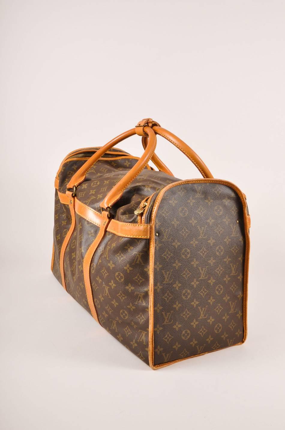 Color: Brown, Tan

Made In: France

Fabric Content: Coated Canvas, Leather, Textile

Item Specifics & Details: Hard case duffel bag.Brown and tan monogram coated canvas with tan leather trim.Two top handles with brass tone links and belt
