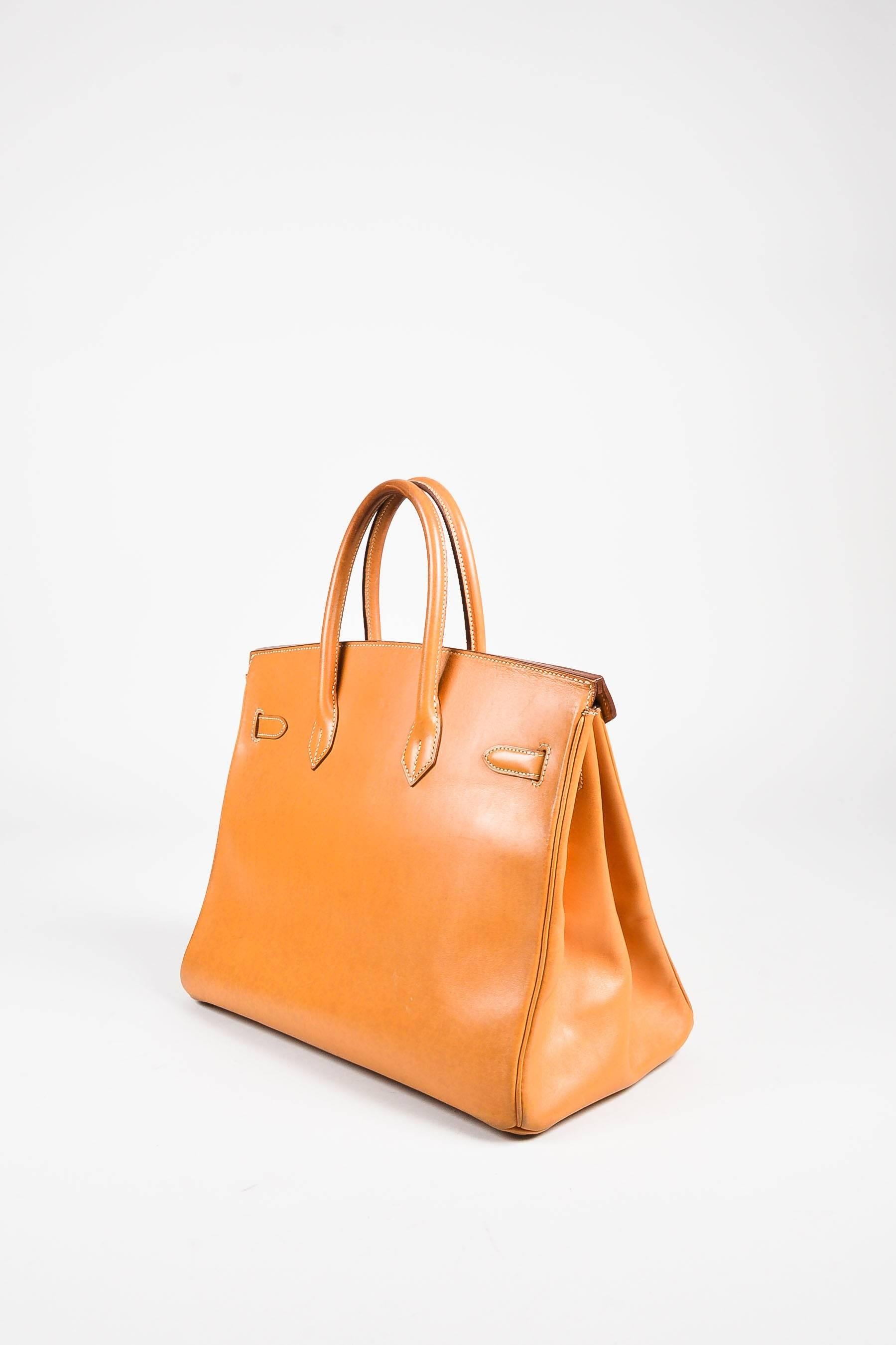 Released circa 1995, as signified by a blind stamp 'Y' in a circle. An elegant piece of iconography, the coveted 35cm "Birkin" satchel bag is constructed of natural colored box calf leather. Features sturdy dual rolled top handles, tonal