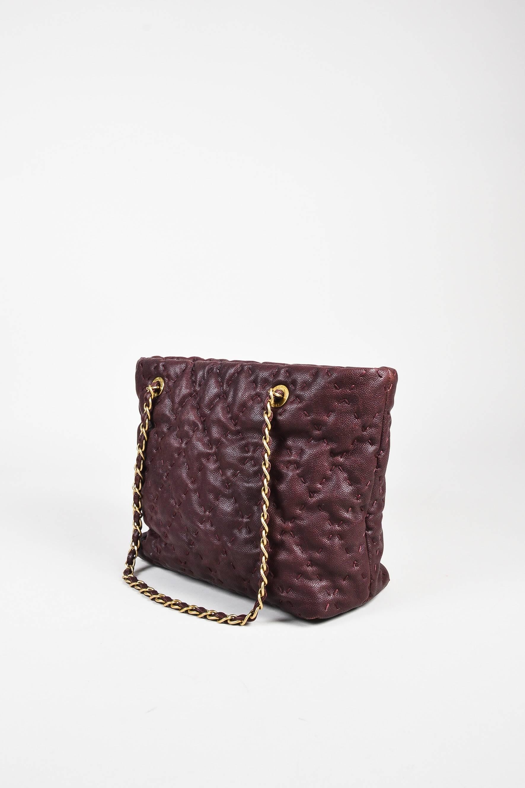 Plum quilted shoulder tote bag by Chanel.  Gold tone chain link shoulder straps, front strap has 