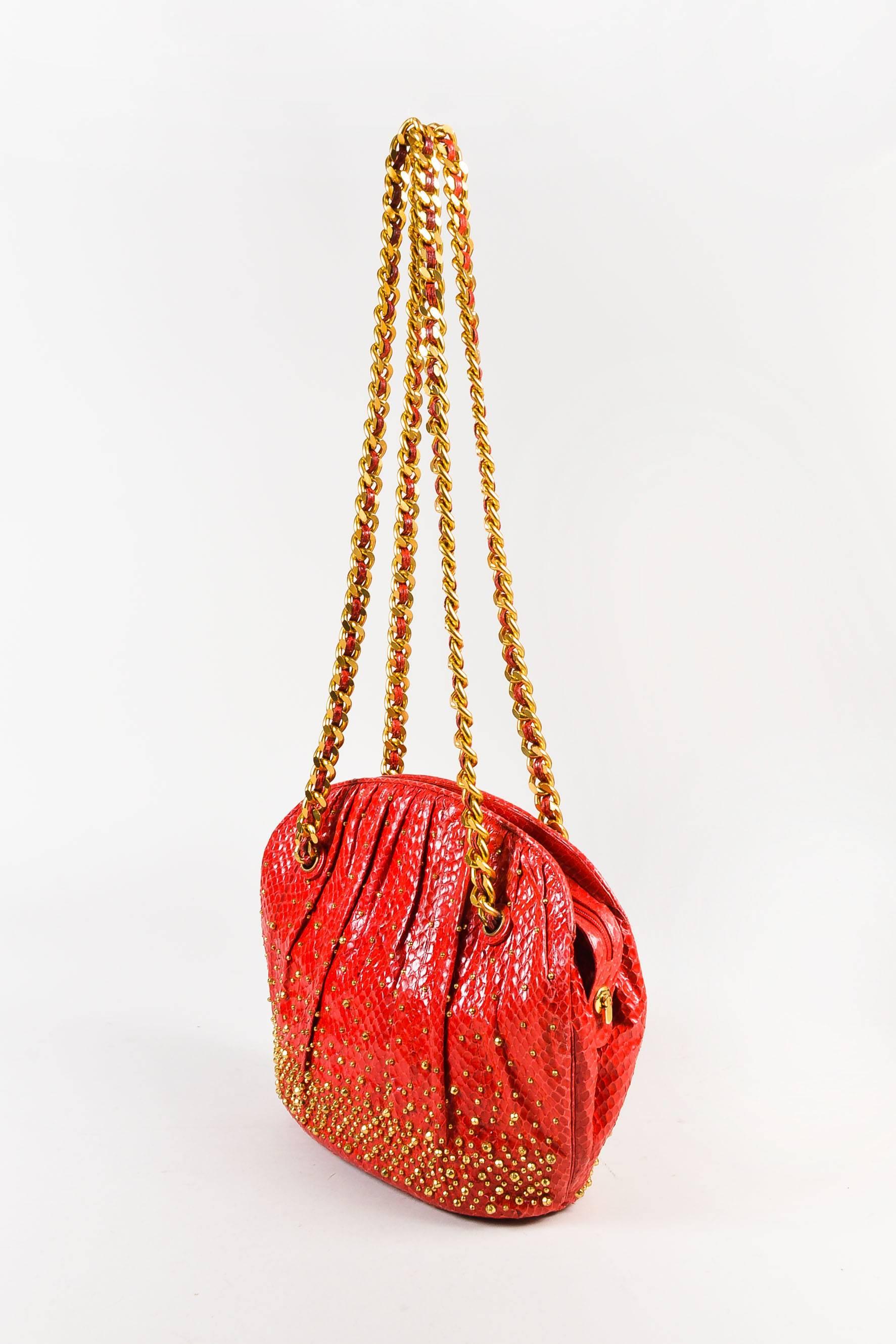 This vintage bag would pair well with black pants and a white ribbed oversized sweater. Comes with a coin purse, comb, and mirror. Red genuine python leather pleated shoulder bag from Judith Lieber features gold-tone studs throughout. Five gold-tone