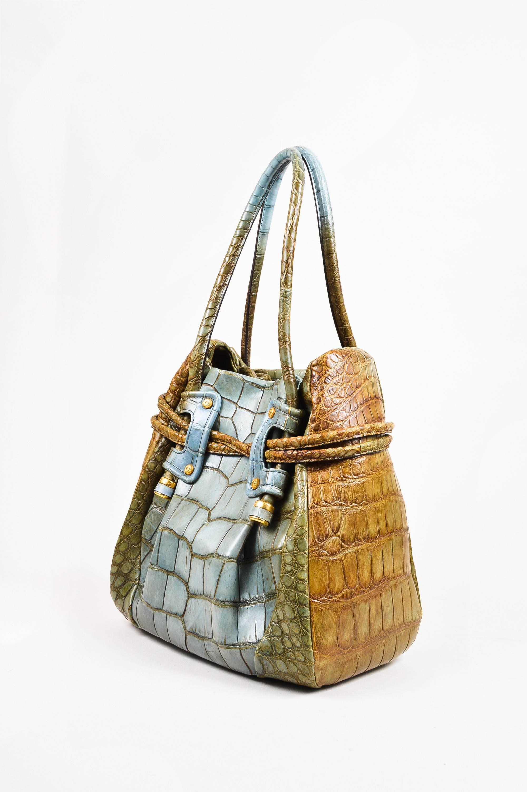 Made In: Italy

Fabric Content: Genuine Alligator Leather; Lining: Suede

Item Specifics & Details: Comes with box, dust bag, brand tags, and care booklet. Retails at $18,000. Olive green and light teal genuine alligator leather bucket bag