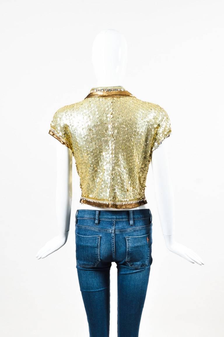 Size: 8
Color: Gold,Metallic,Silver,
Made In: Italy
Fabric Content: Nylon

Item Specifics & Details: This dazzling top from Valentino is perfect to pair with a pencil skirt for a night out. This embellished button down top features gold and