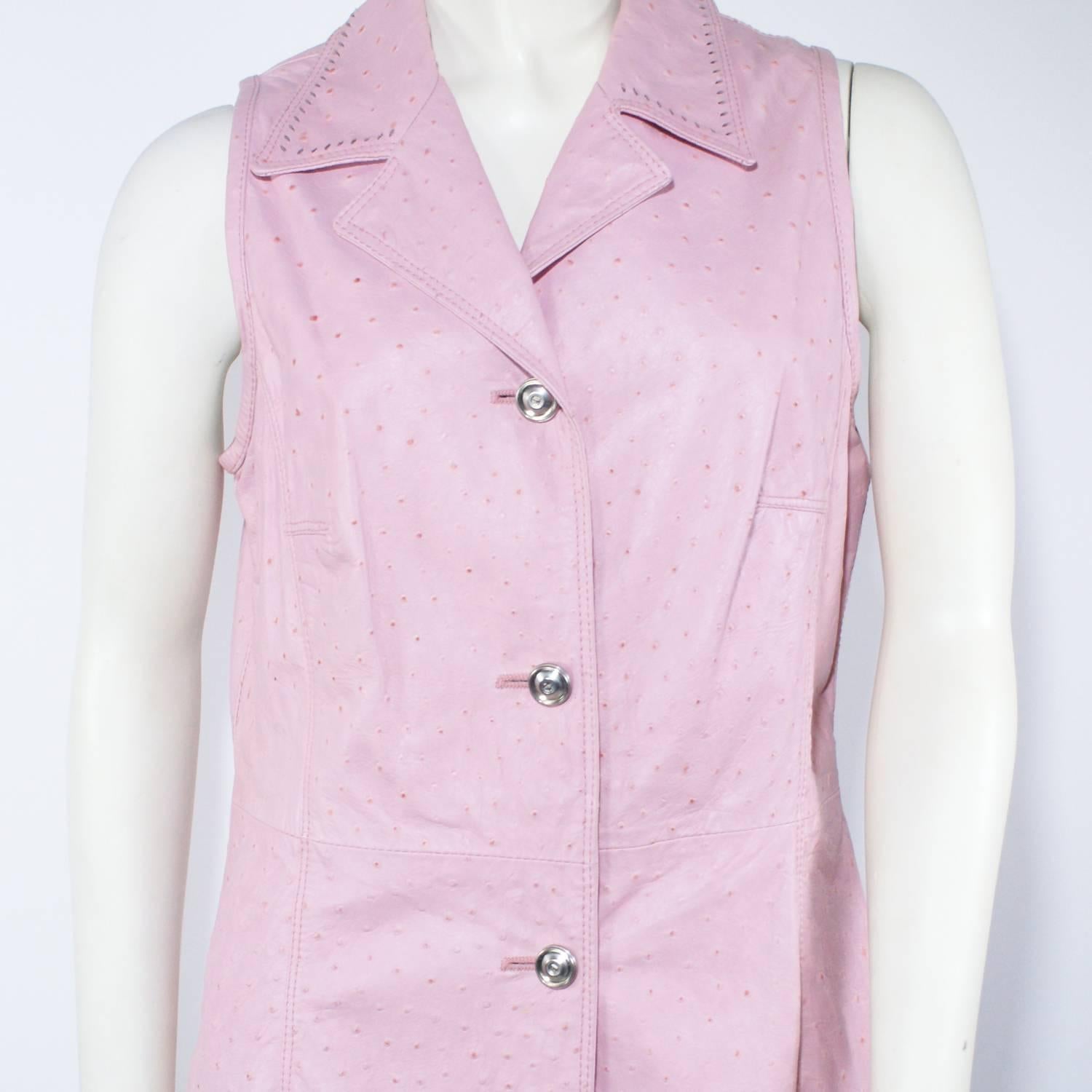 A textured pink leather vest
Silver button closure
Perforated detail at the collar
Fits like a size small  6
