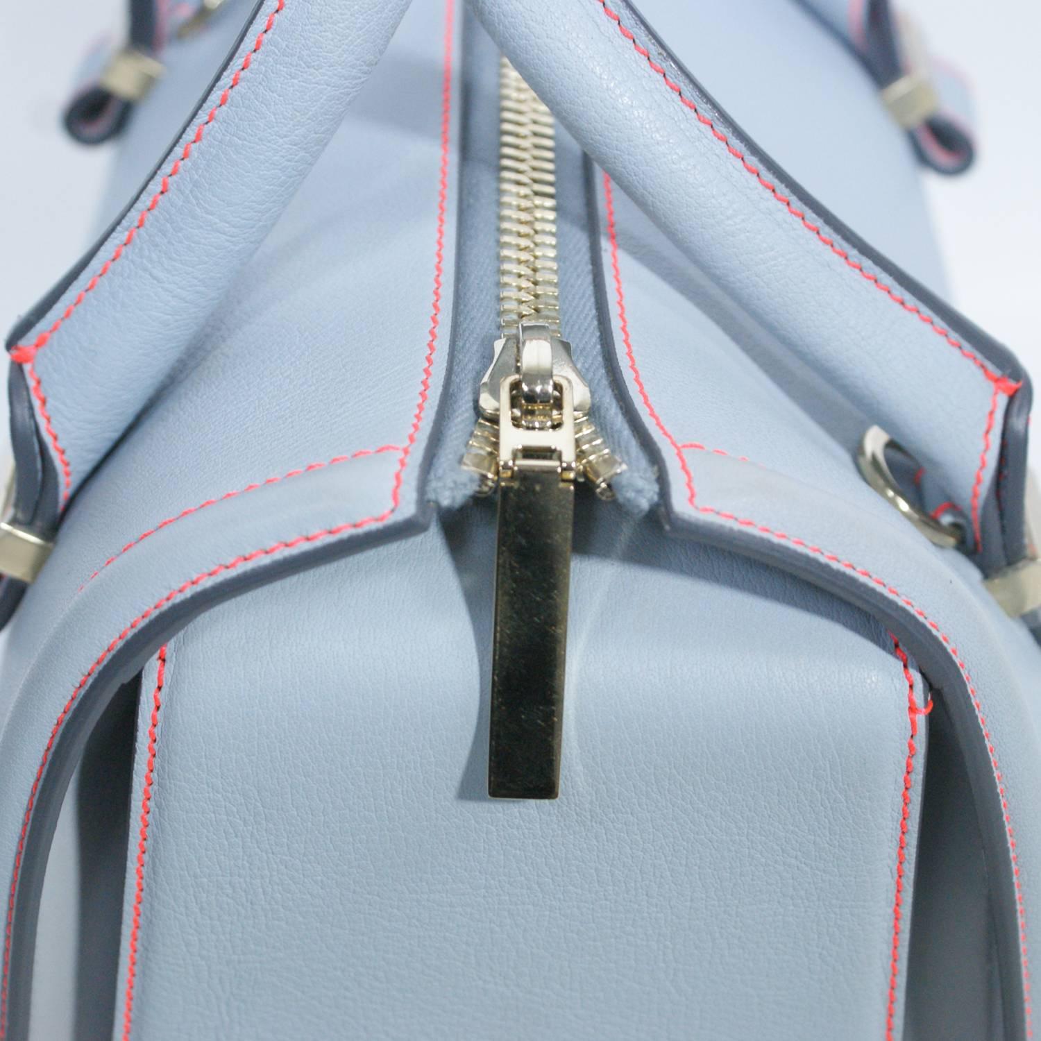 Light blue leather
Pink stitching
Silver tone hardware
Two Handles
Top zip closure 
Originally $1100.00