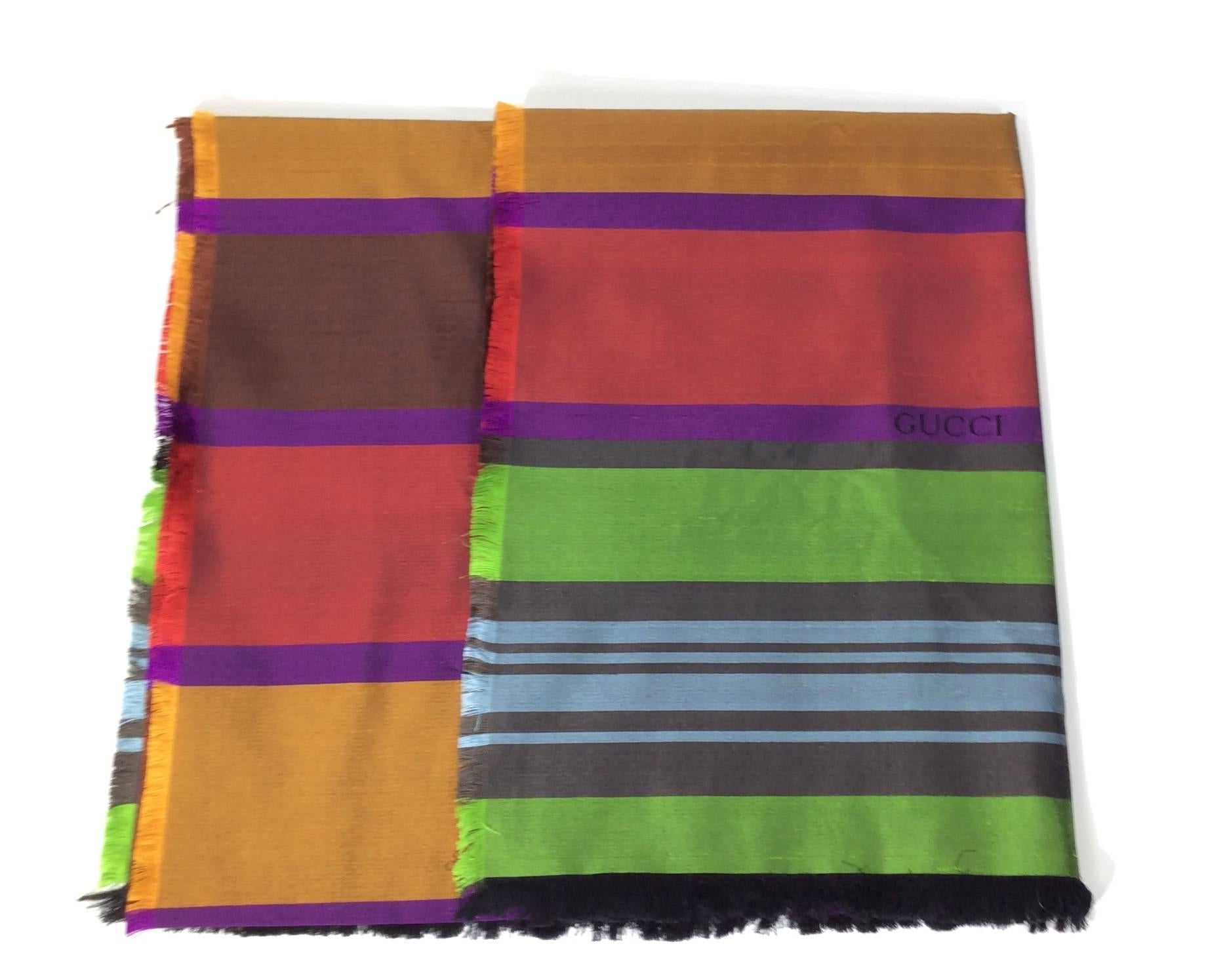Multicolor Striped Woven Scarf
64''x28'' dimensions
Includes fringe on scarf edges
Gucci name woven into alternating stripes
70% Cotton, 30% Silk