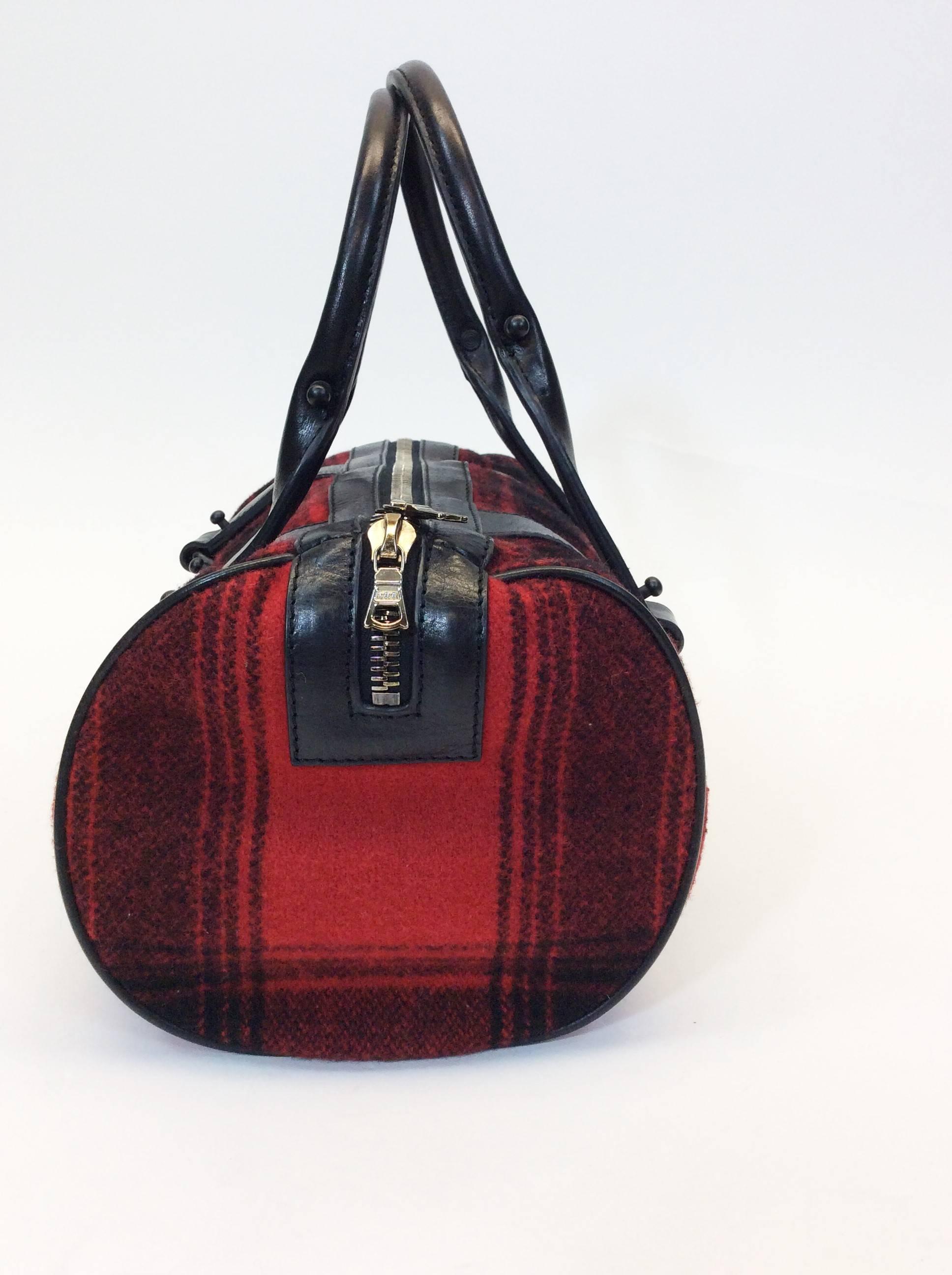 Black and Red Flannel Handbag
Black Faux Leather Handles and Embellishments 
Silvertone Double Zipper Closure 
Single Interior Pocket
Includes Complimentary 3.1 Phillip Lim Dust Bag
9