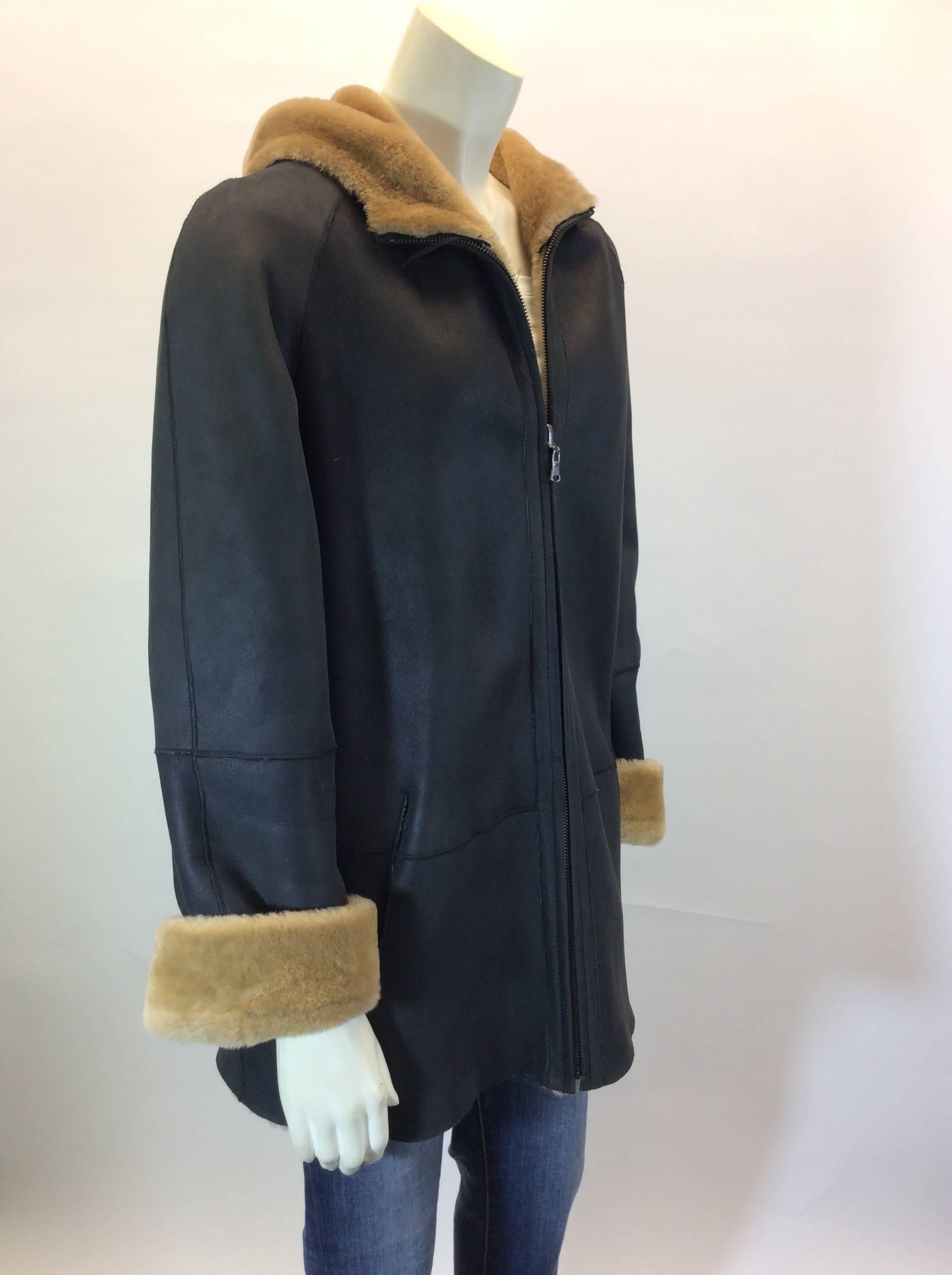 100% Sheepskin
Fully Lined with Tan Sheepskin 
Deep Brown Suede Exterior 
Zipper up Front for Closure
Single Pocket on Either Side
Size Small