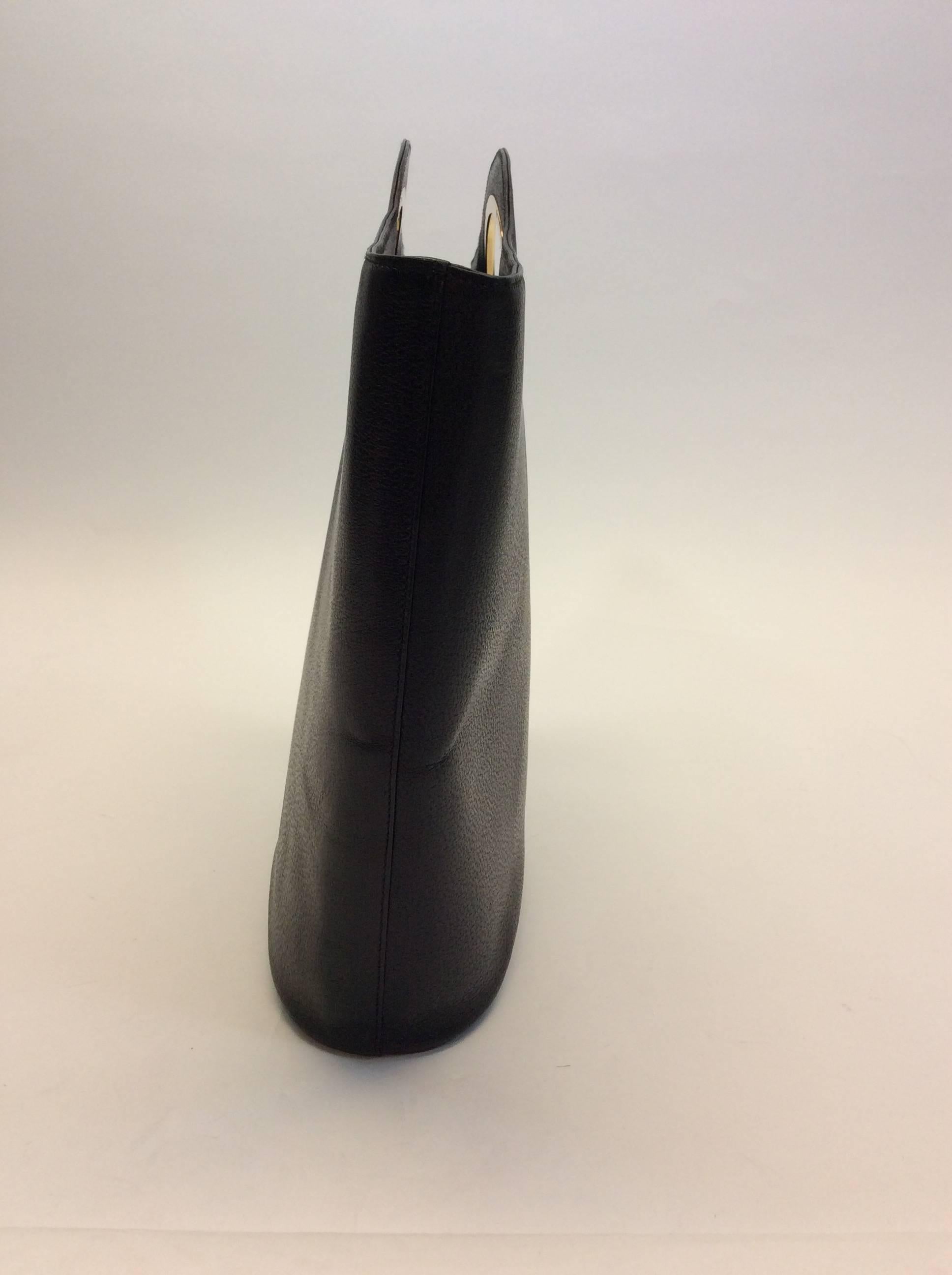 Genuine Black Leather 
Goldtone Hardware
Zipper on Inside for Closure
Pocket on Interior of Bag
