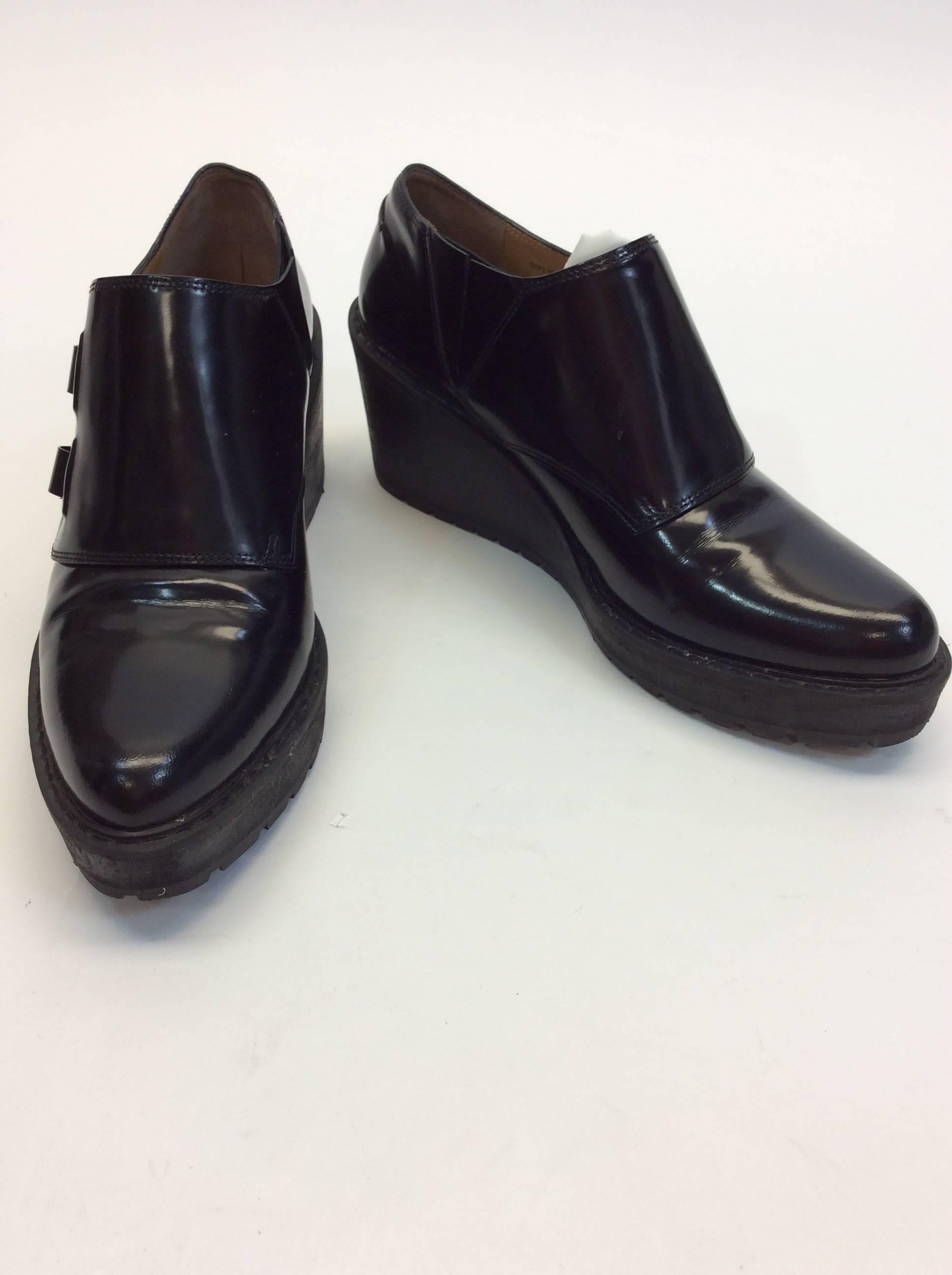 Black Patent Leather
Includes Dust Bag
Clasps on Sides for Closure
Rubber Soles
3" Inch Heel
4" Inch Sole
Original Price: $525.00