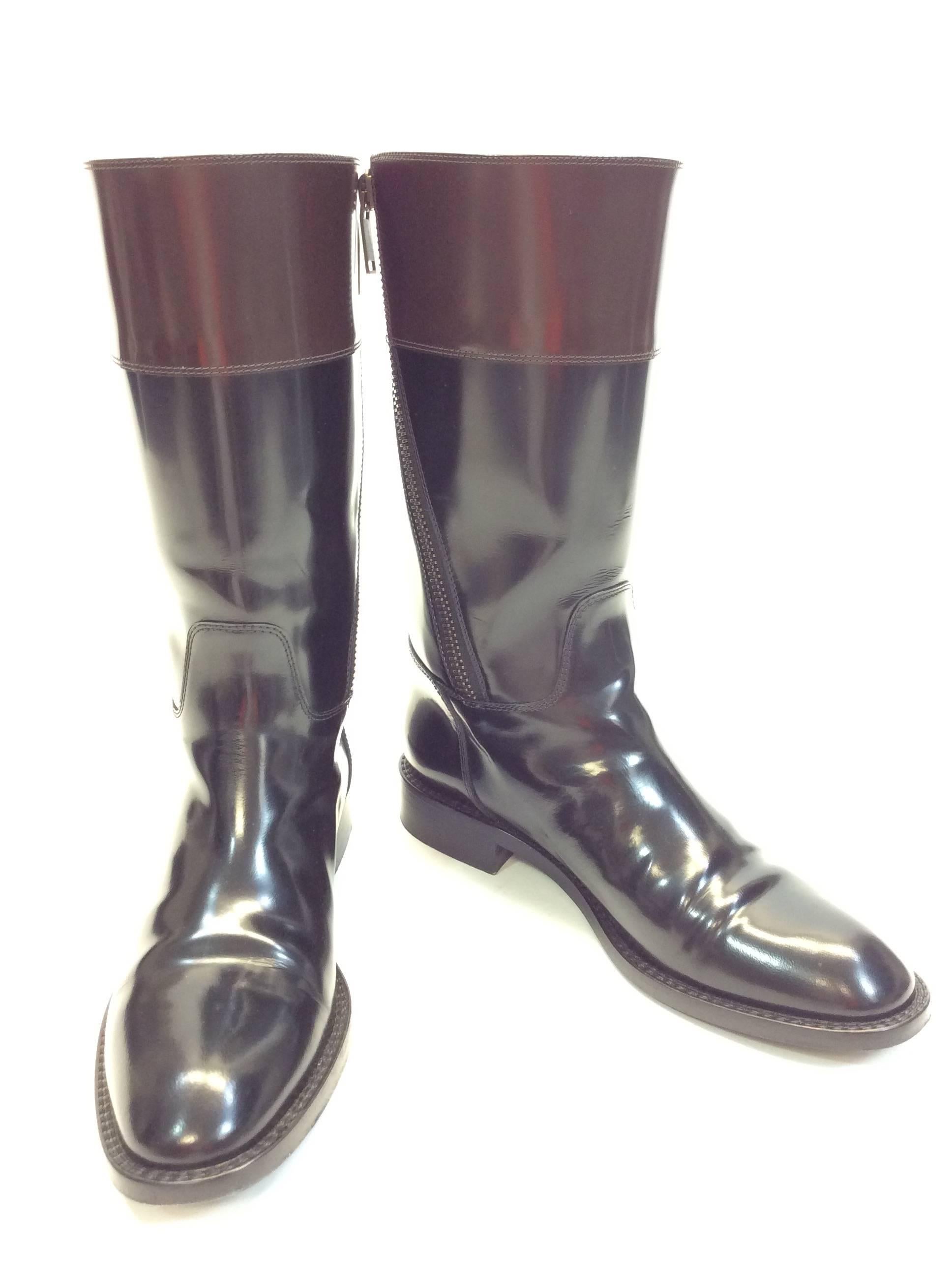 Black and Brown Patent Leather
Brown at top of Boot
Angled zipper on side for Closure 
Saint Laurent Logo on side of Boot
Minimal wear to Bottom of Shoe
4" Inch Sole
12" Inches High