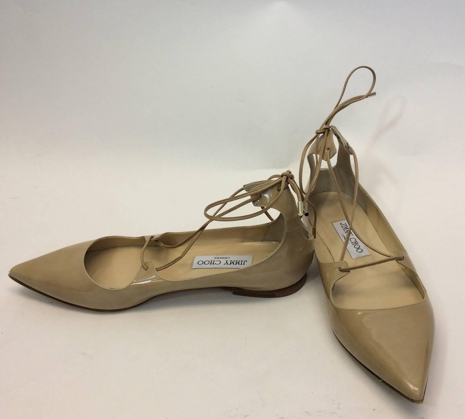Tan Patent Lace Up Flats
3.5 inch sole width
Patent ties behind heel
Size 38.5 (Equates to US 8)
Leather and wood sole, :leather upper and lining