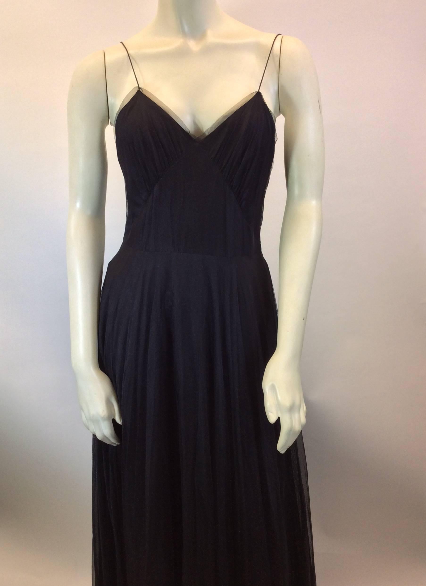 Black Tulle Evening Dress
Features buttoned back closure
Very thin shoulder straps
Tulle trim around bust
Size 38 (equates to US 6)
100% Polyamide shell, 60% Silk, 40% Viscose lining