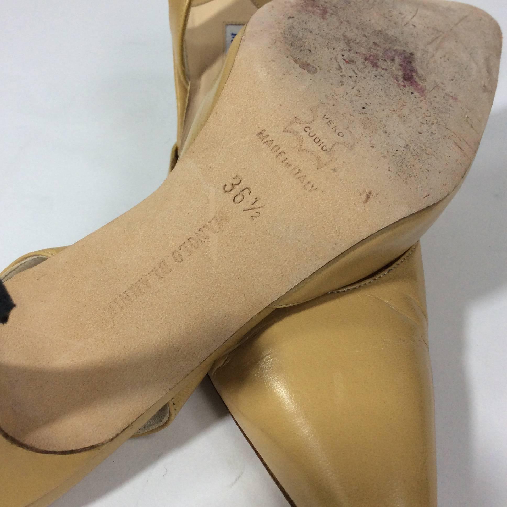 Manolo Blahnik Tan Pointed Heels with Heel Strap with a 1 inch heel. Size is a size 36.5 which equates to a 6 as the shoe runs small. Shoe is in great condition with minimal wear on the sole. 