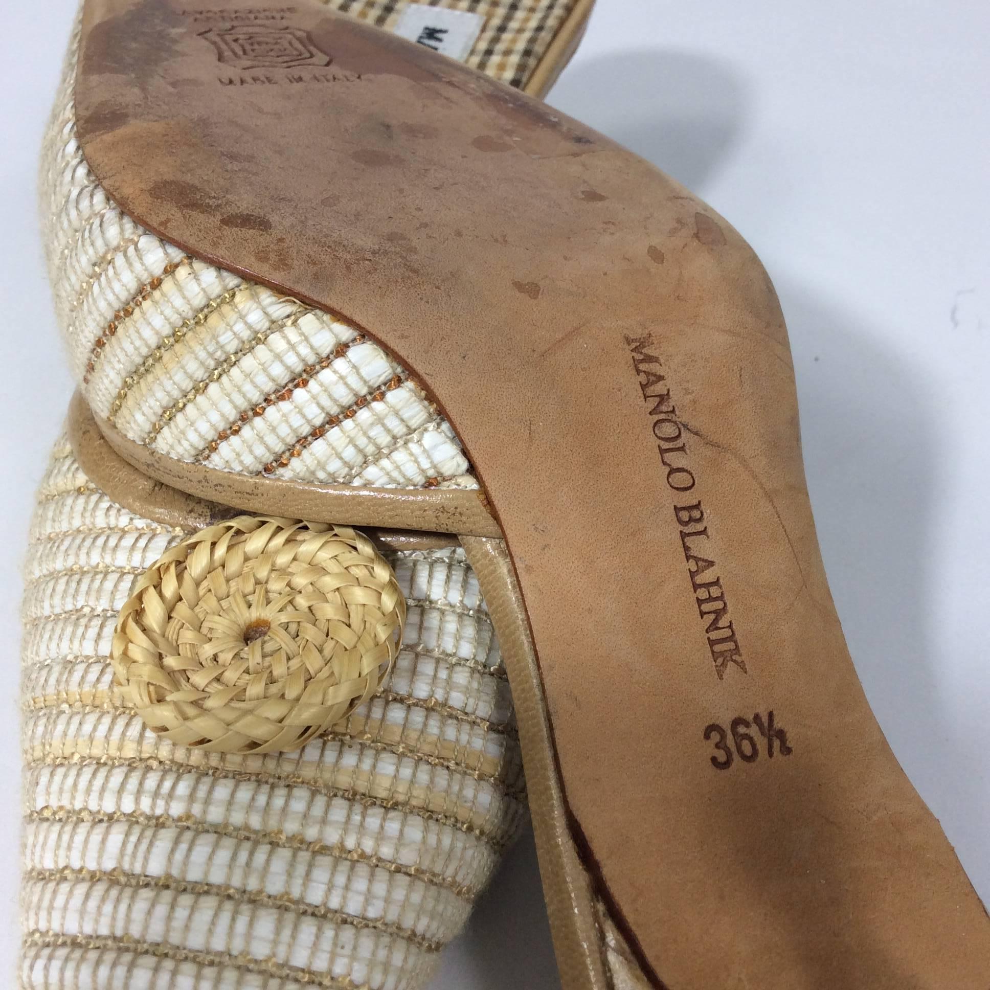 Manolo Blahnik Tan and Cream Pointed Slides with Wicker Detail with a _ inch heel. The size is a 36.5 which equates to a 6 as the style runs small. Shoe is in overall great condition with minimal wear on the sole.