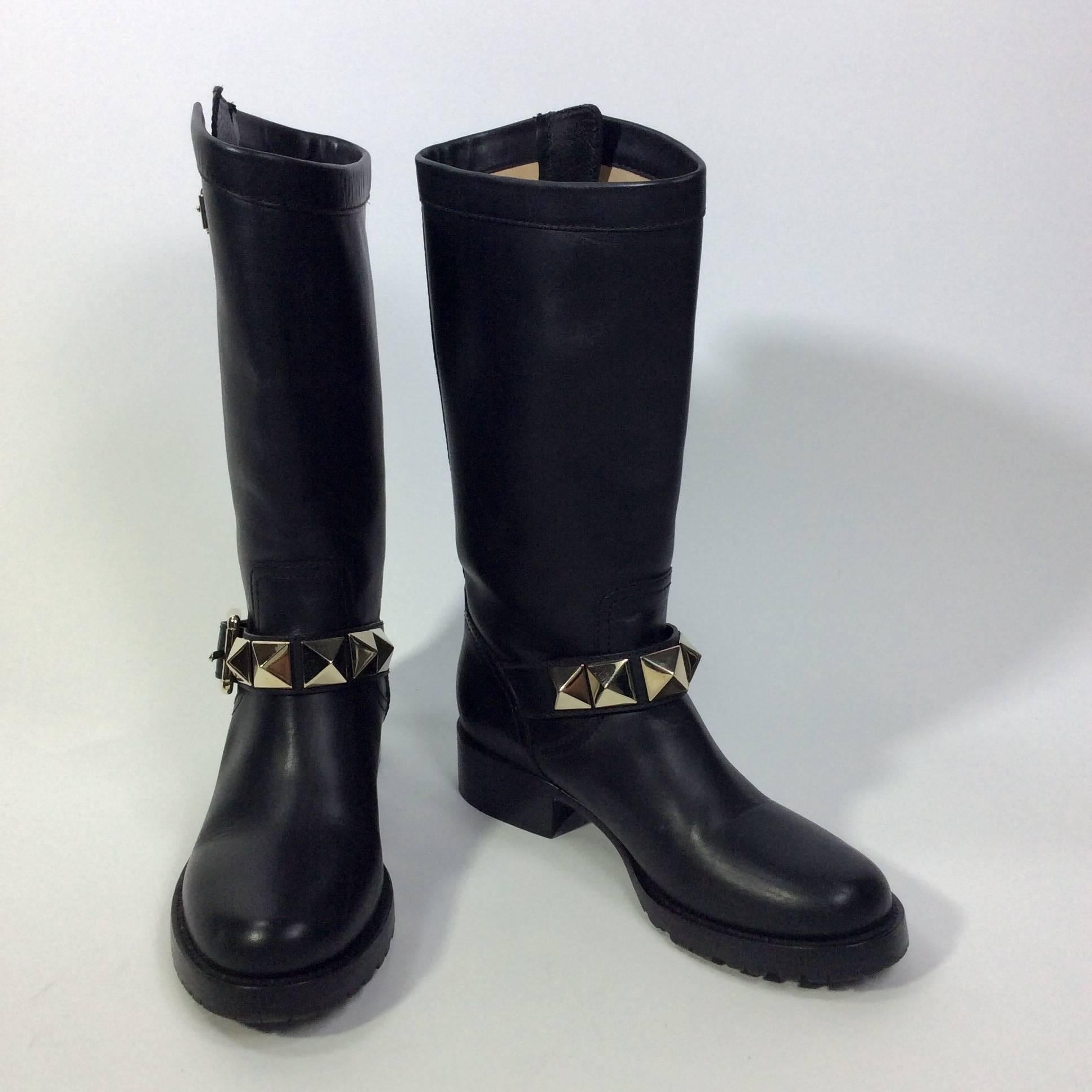 Black Leather Calf Boots with Silver Studs
1.5 inch heel
0.75 inch platform
3.75 inch sole width
Buckle closure for size adjustment on outside of calf
Buckle closure on studded ankle strap
Size 35.5 (equates to a US 5.5)
Leather and metal