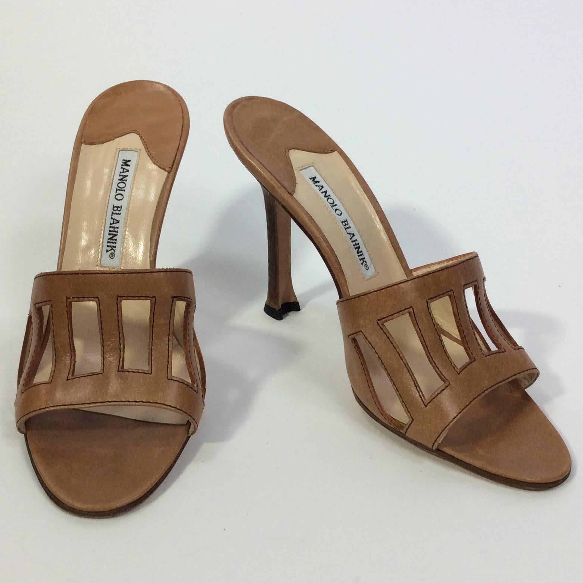 Tan Slide with Rectangular Cutouts
4 inch wooden heel
3 inch sole width
Black topstitching around cutouts
Size 37.5 (equates to US 7)
Leather upper and leather sole