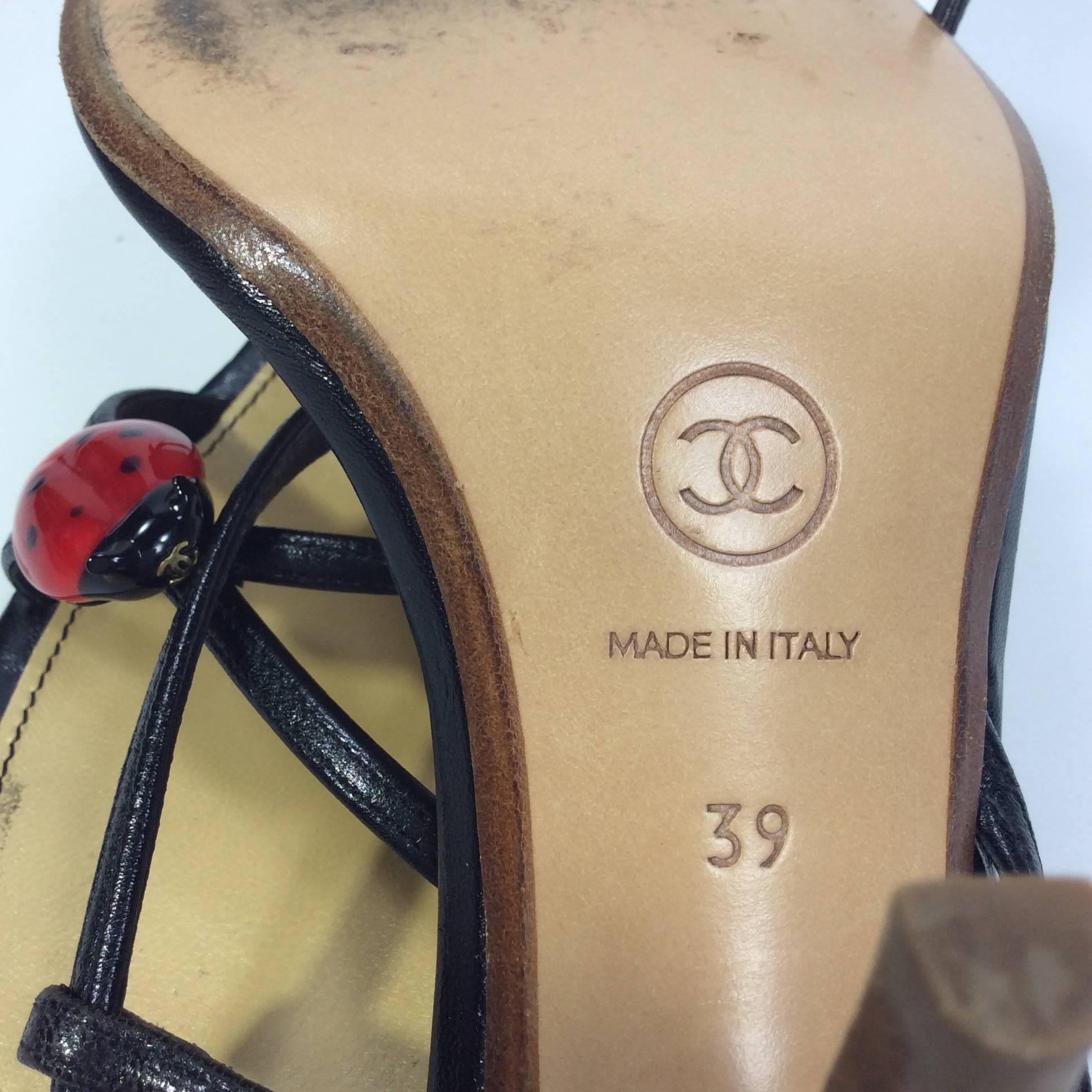 Black Strapped Slingback Heels with Ladybug
3 inch heel
3.5 inch sole width
Glass ladybug detail with Chanel logo eyes
Elastic on back of ankle strap for stretch
Size 39 (equates to US 9)
Wooden heel with leather straps and leather lining