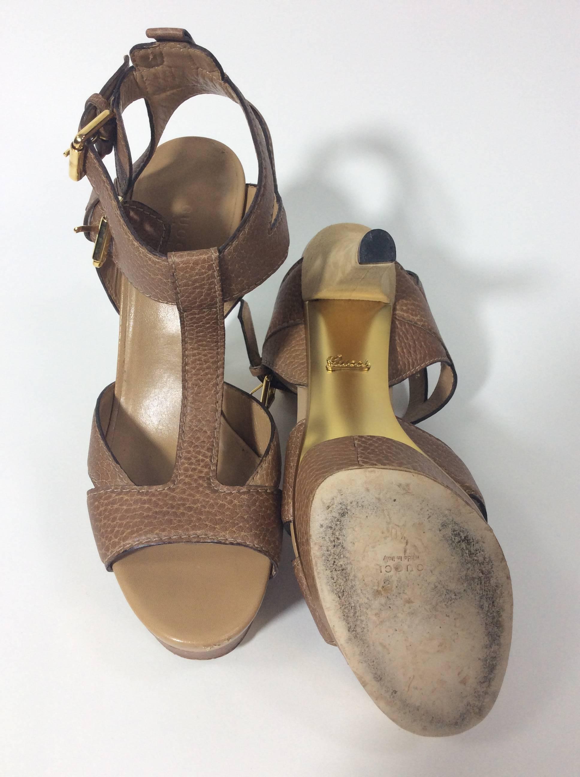 Tan Platform Strap Sandals
5 inch heel with a 1.5 inch platform
Buckle closures on outside of ankle
T-strap style sandal with cross strap details
Size 40 (equates to US 9)
Leather sole, suede heel, leather upper and lining