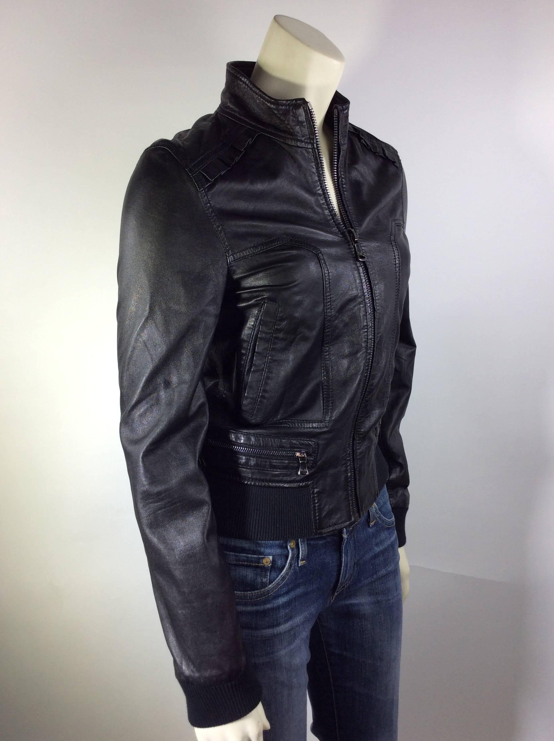 Black Leather Zip Up Motorcycle Jacket
Pockets on Either Side
Silvertone Zipper
Ruched Leather Detail on Shoulders and Back
100% Lambskin
UK Size 36 (Equates US 6)