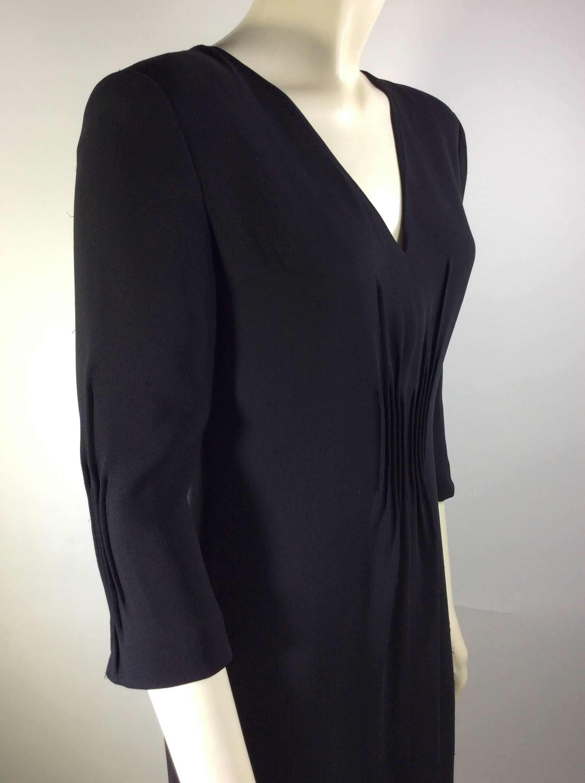 Giorgio Armani Black Crepe Detail on Front Dress
Mid Length Sleeve 
Small Slit in Front 
Zips up The Back
UK Size 38 (Equates US 8-10)