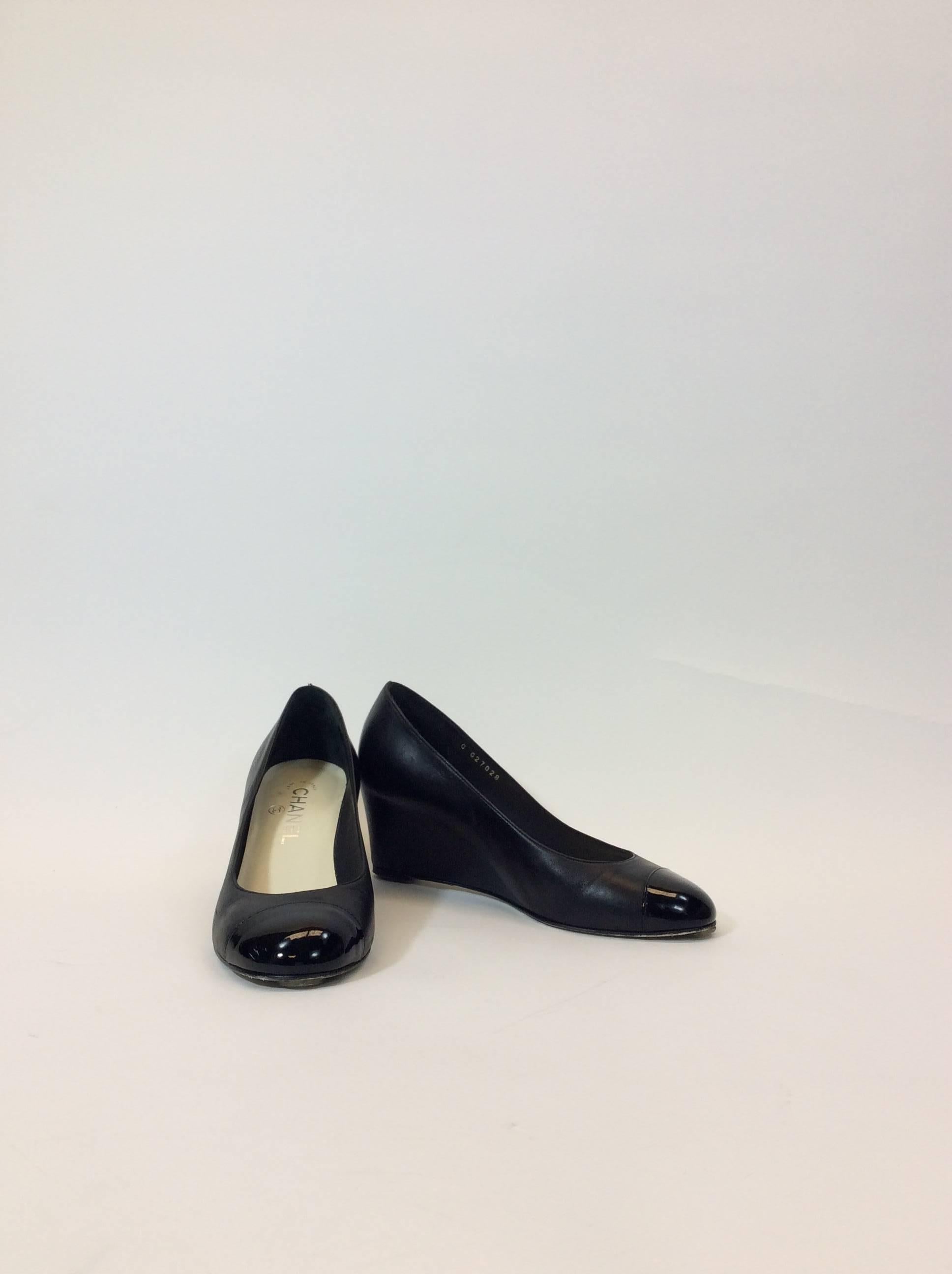 Black Leather Wedge 
Patent Leather Trim on Toe
Silvertone CC On side of Heel
Wear on Bottom of Shoes
2.5" Inch Heel
3" Inch Sole