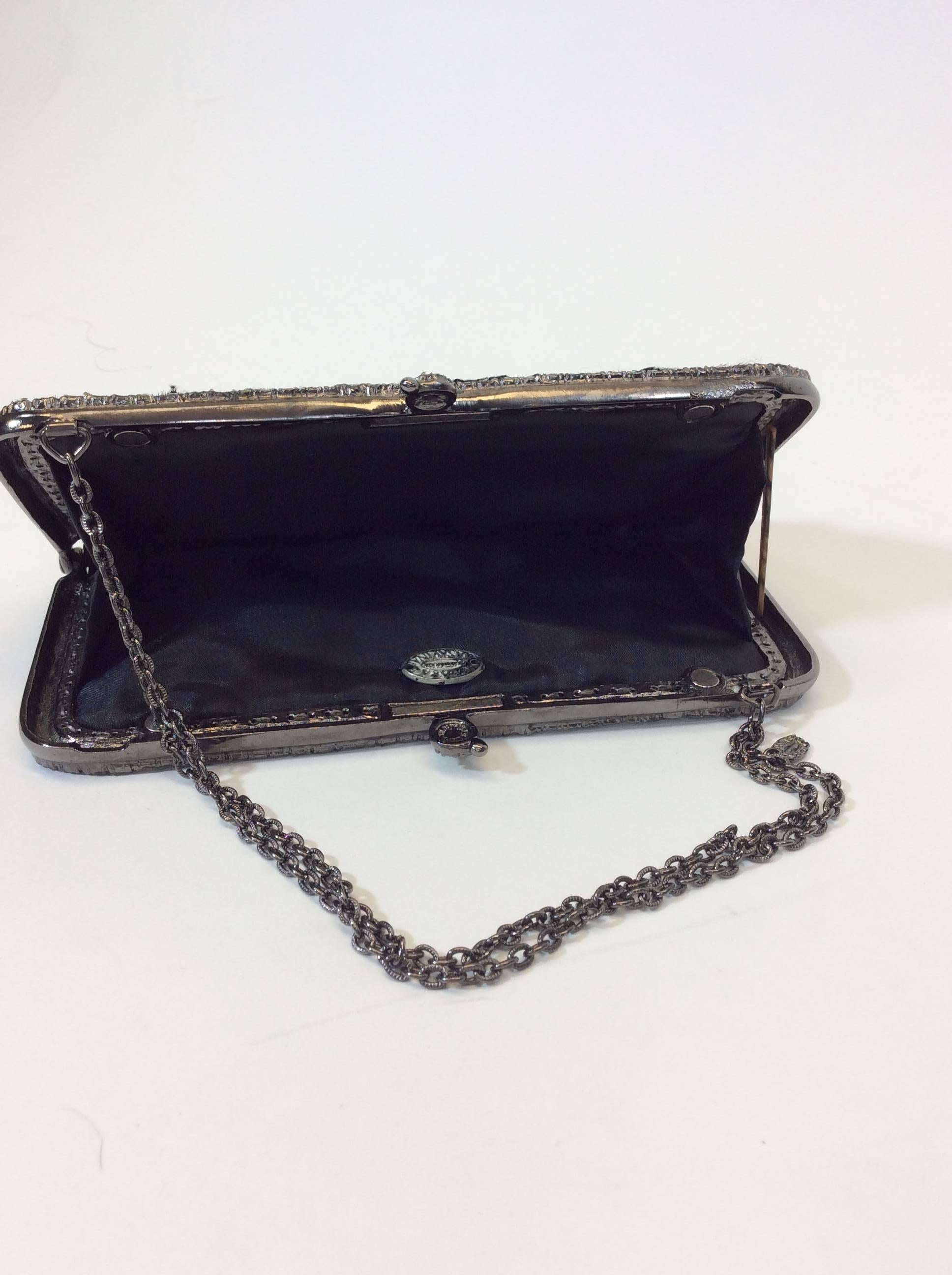 Handmade Clutch with Short Metal Chain
Soft Black Fur Exterior 
Elegant Rhinestone lined edges and Clasp 
Faux Silk Interior 
Magnetic Clasp to Close