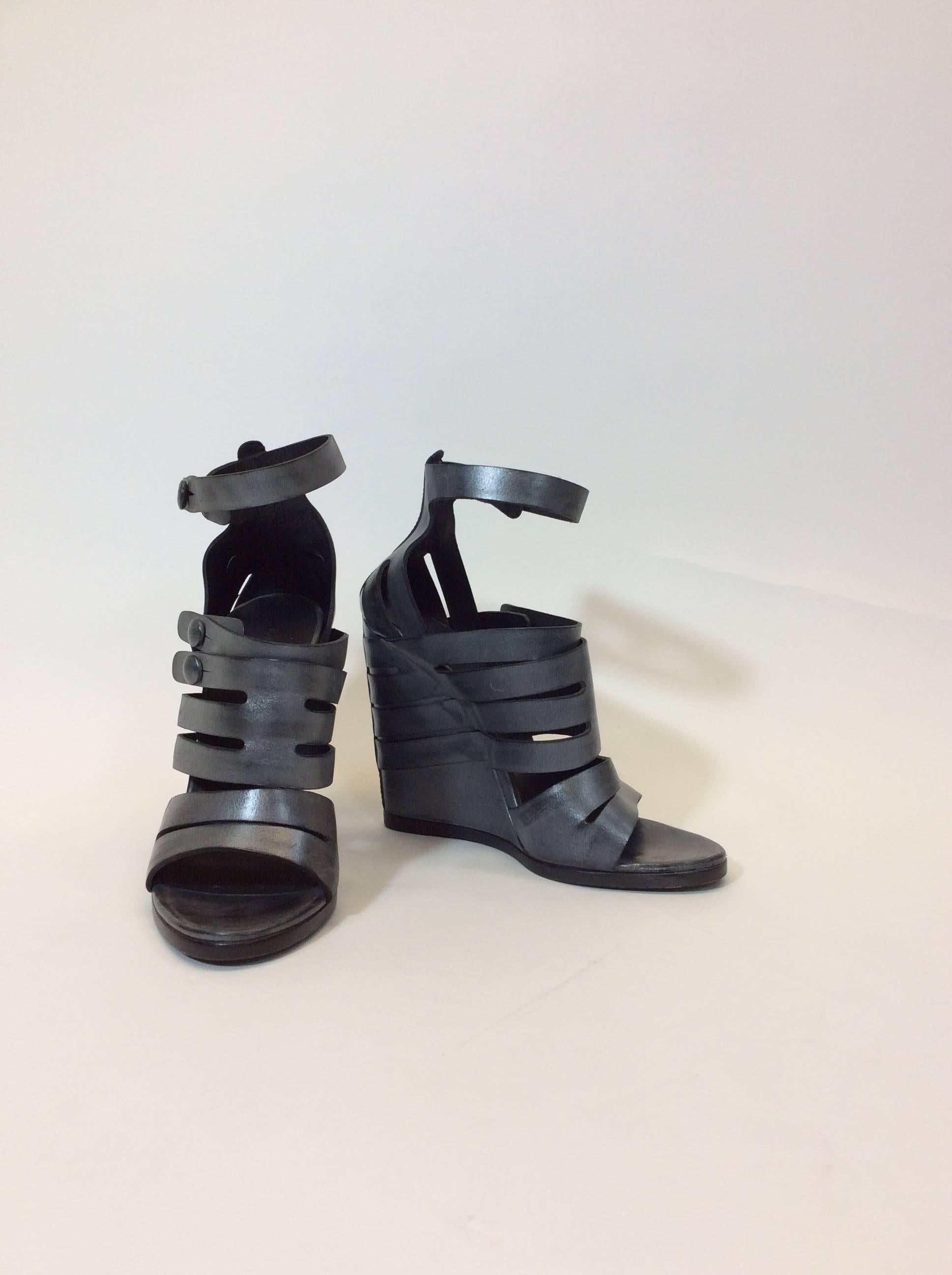 Deep Silver Metallic 
Three Button to close Straps 
Minimal Wear along bottom and the Soles
4.5