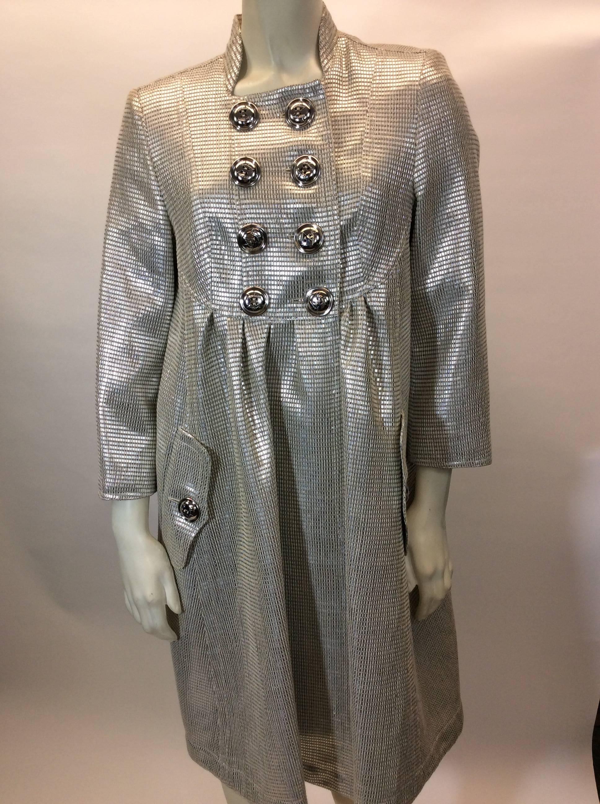 Burberry Evening Coat
-Size 42
-Lined
-Silver Metallic, w/ cream weave
-2 front pockets
-Silver metal buttons

*One button missing, extra button needs to be sewn on - noted in photo