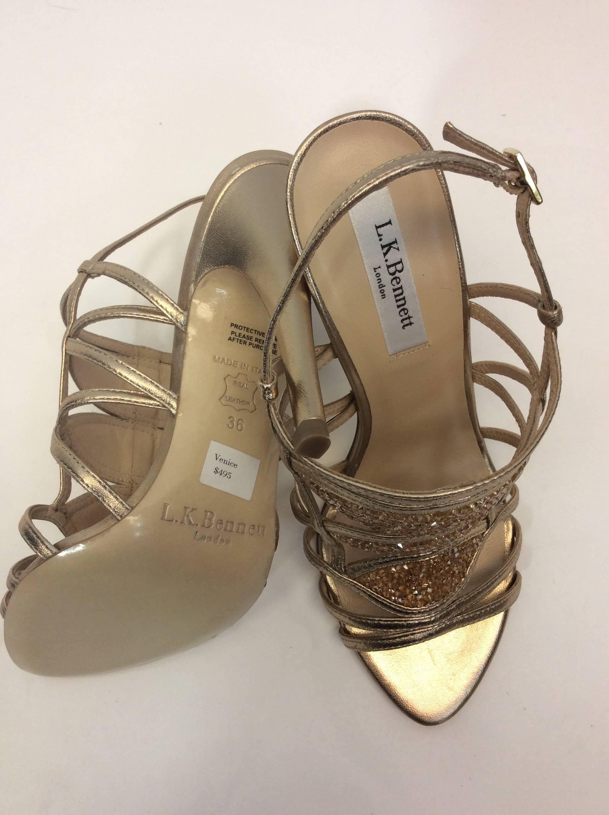 Gold Beaded Sandal
4.5 inch heel
3.25 inch sole width
Buckle closure on ankle
Metallic leather texture with beaded sections
Size 36 (equates to US 5.5)
Leather sole, upper and lining