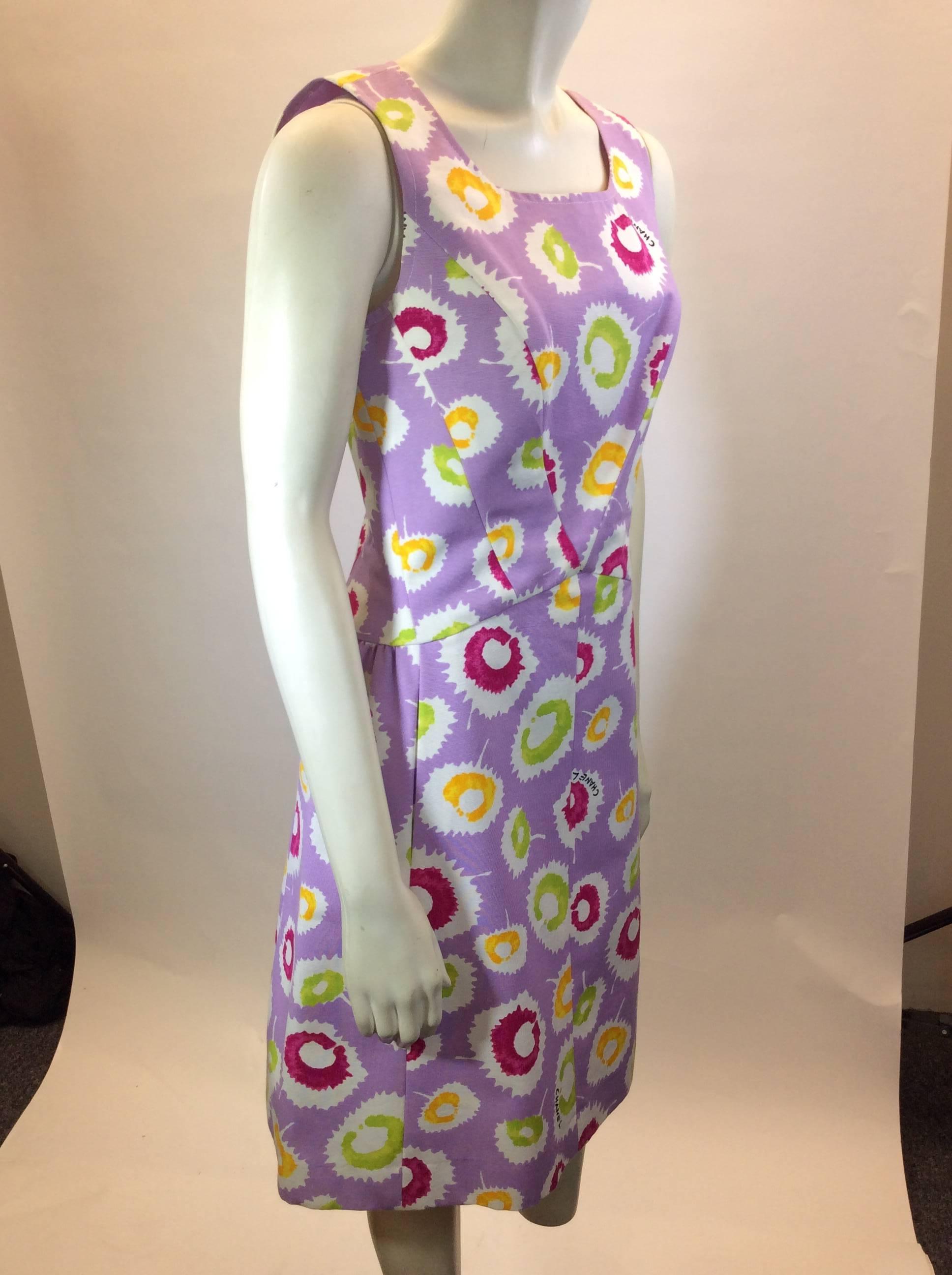 Sleeveless lavender Chanel dress with orange, pink and green circle prints. 100% silk lining. Zip up back 