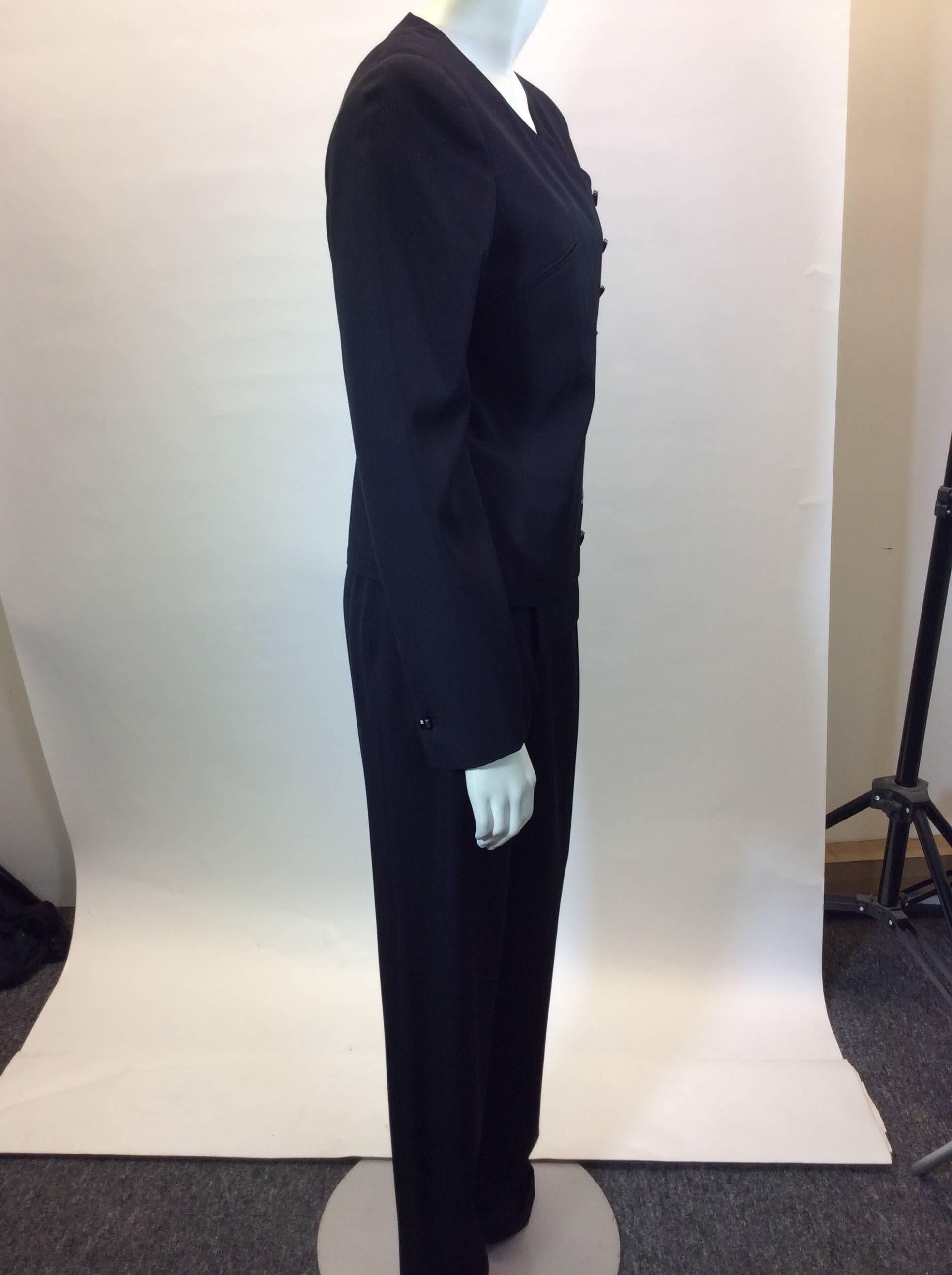 Chanel Black Pant Suit
Suit is 100% wool
100% silk lined
Buttons going down the side of the blazer spell Gabrielle 
Size 40