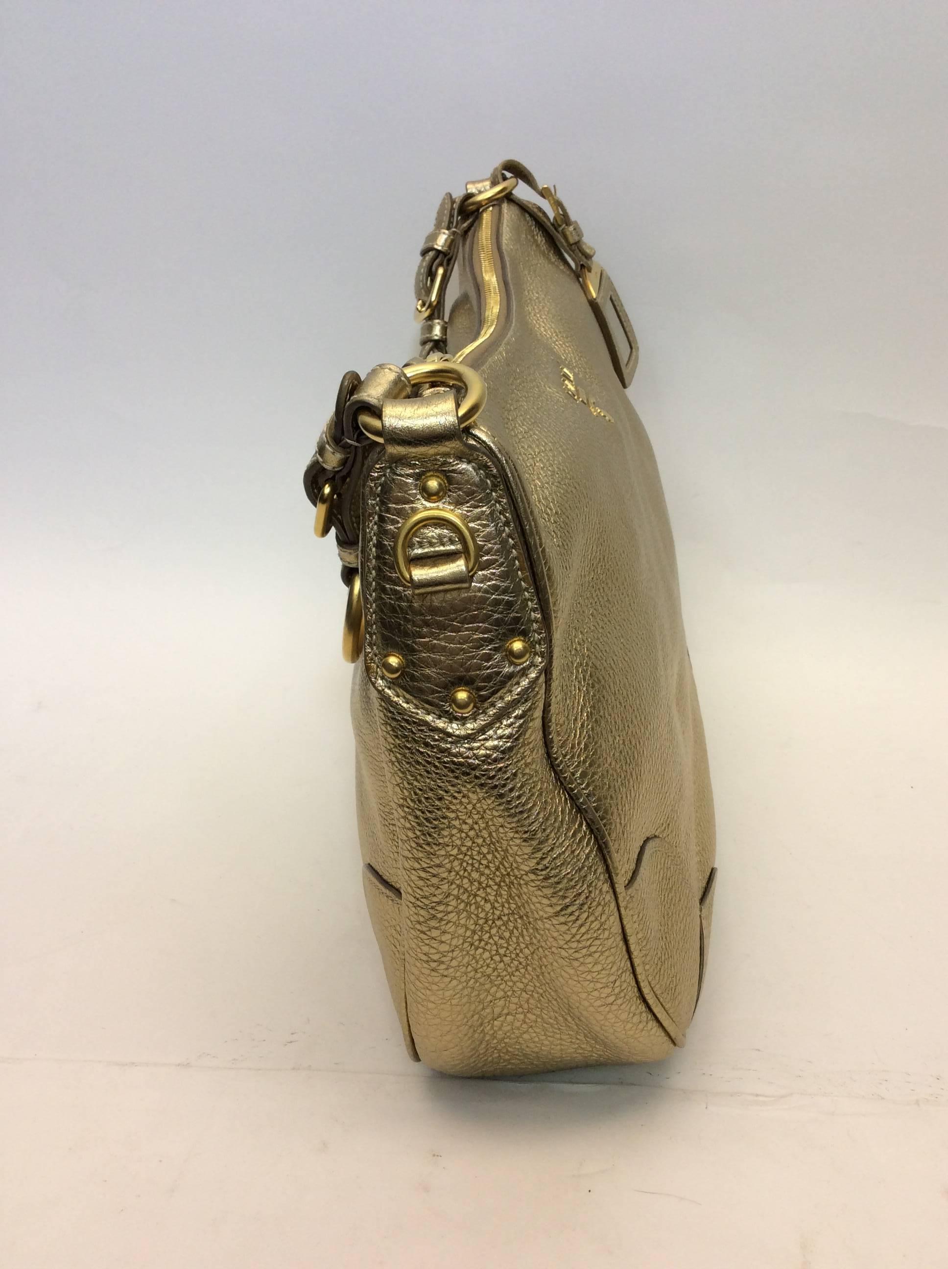 Gold Leather Hobo Bag
15 inches wide, 11 inches tall and 4 inches deep
7 inch strap drop
Includes gold buckled Prada fob
Zipper top closure
Features one zipped and one open interior pocket
Leather exterior with woven lining
