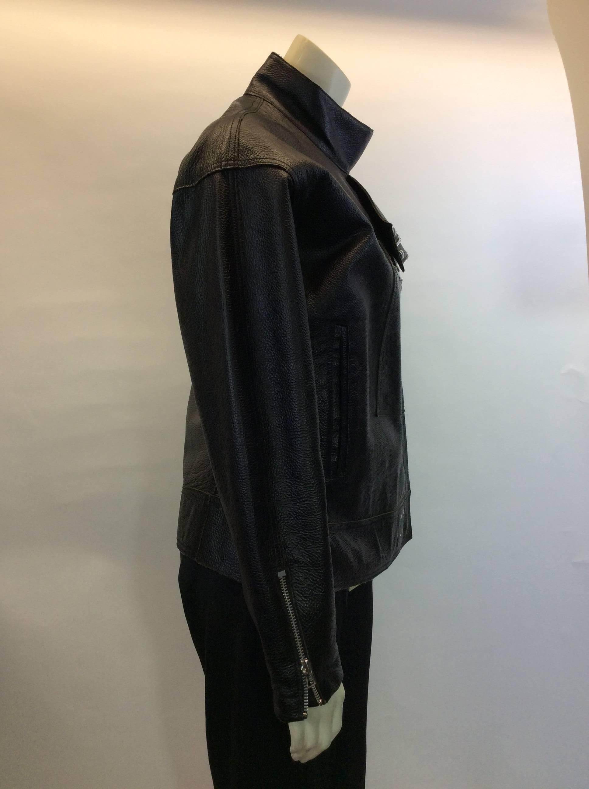 Boxy Convertible Leather Moto Jacket
Includes 3 button front closure, as well as zipper closure
Collar and waistband feature two hook and eye closures
Includes two hip pockets and one interior chest pocket
Size Medium
100% Leather