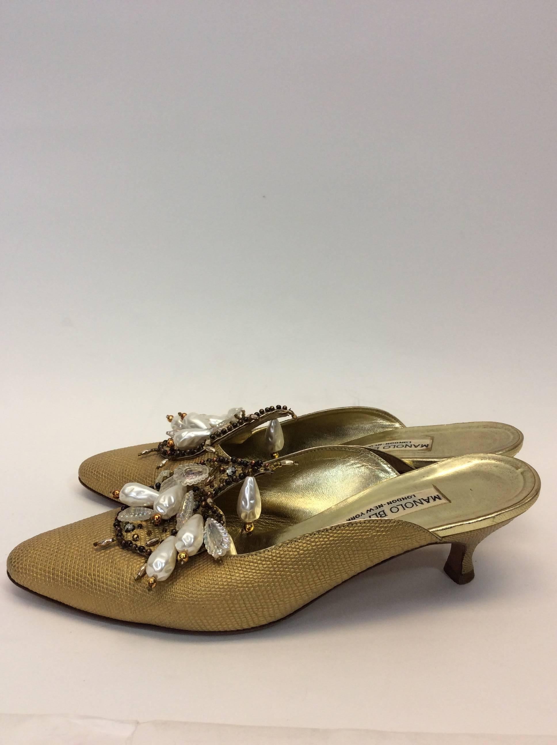 Manolo Blahnik Slides
2 Inch heel
Pearl and rhinestone embellishments
Gold leather
Made in Italy
Size 39