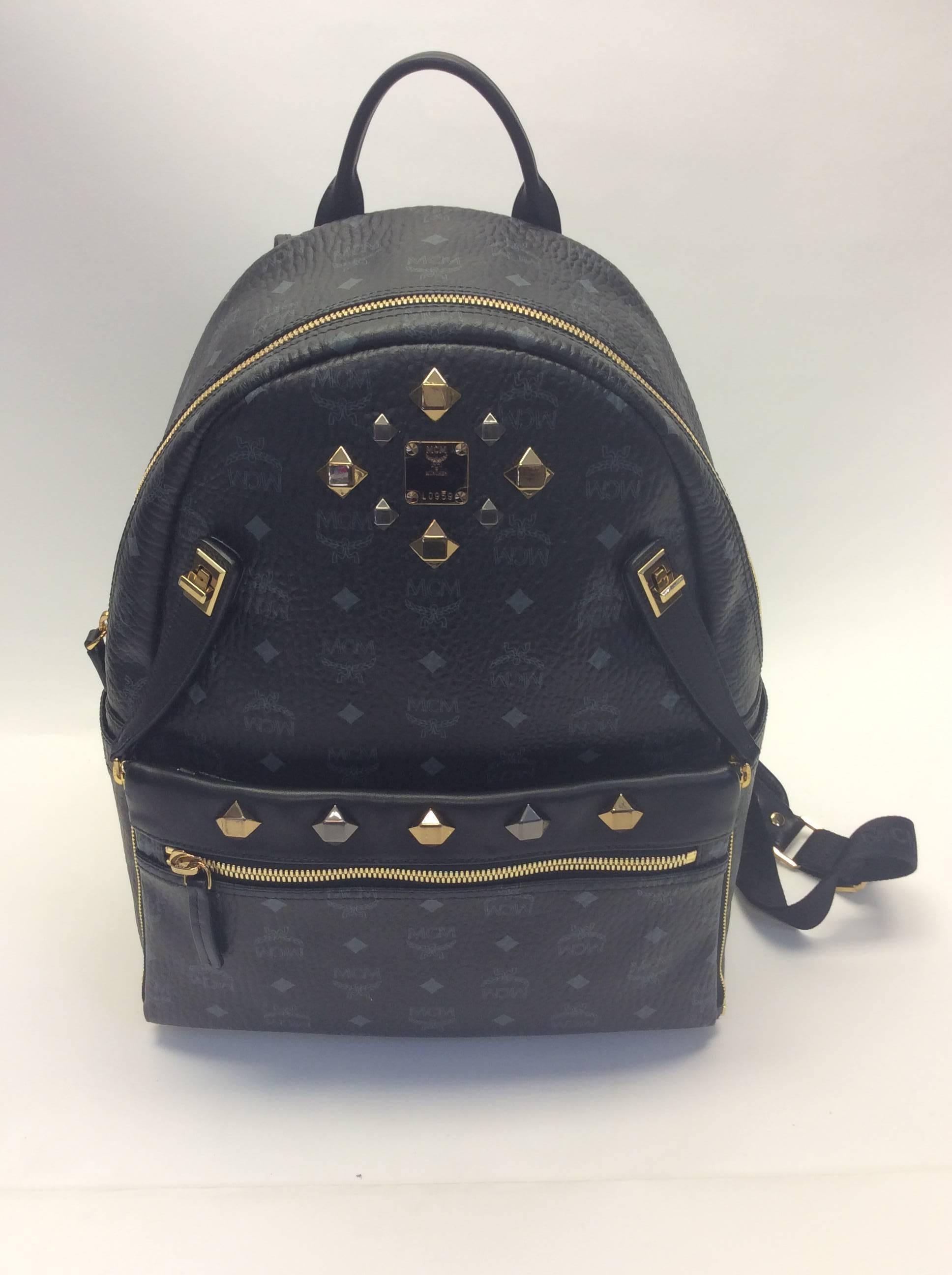 MCM Leather Logo Studded Black Backpack
Golden & silver oversized studs
Padded backpack straps
13 inches width, 15 inches height,  6 inches depth
New without tags
Inner strap included & still in packaging
Made in Korea
