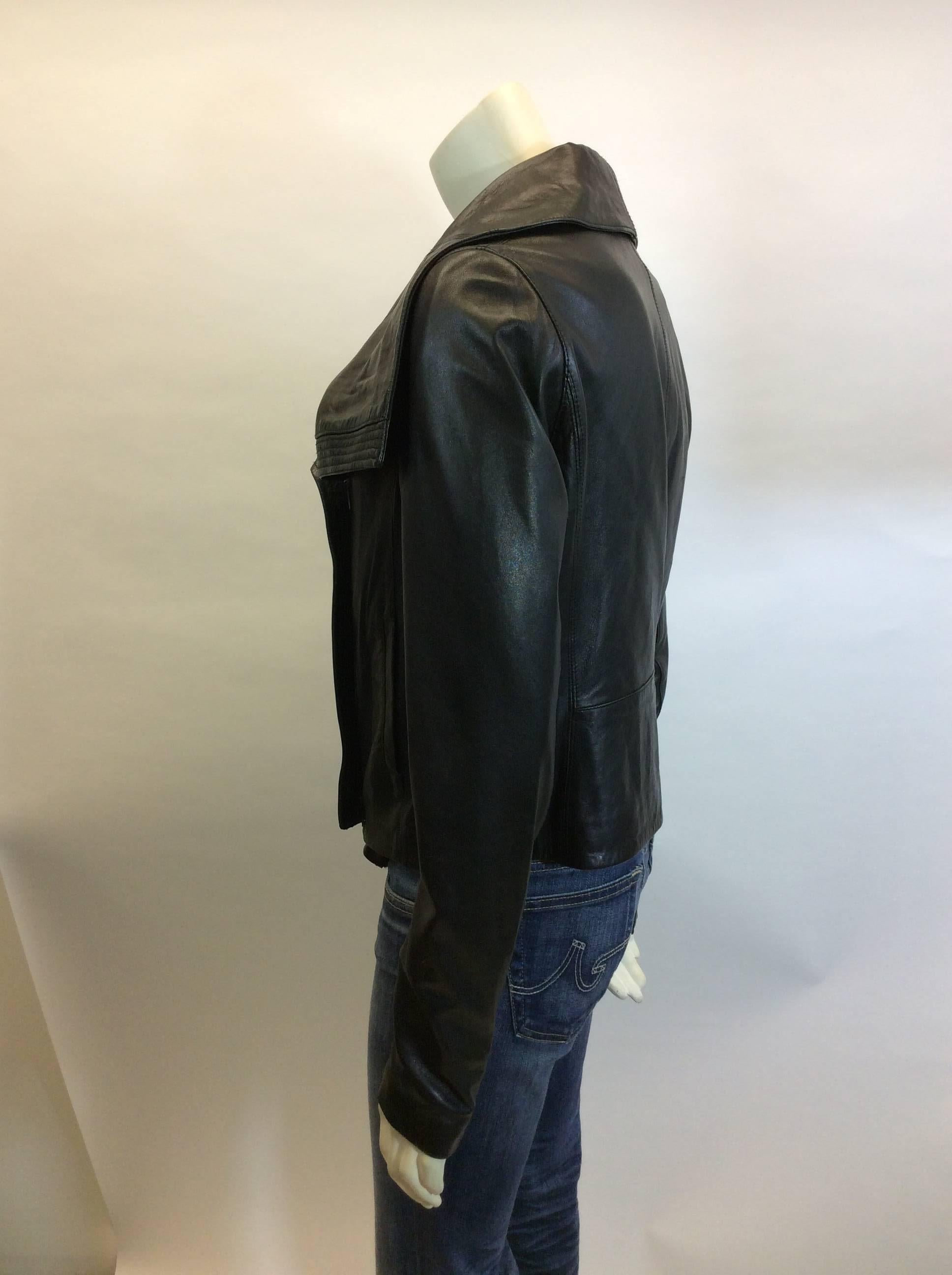 Vince Black Leather Moto Jacket
100% leather exterior, cotton lined interior
Two front pockets, zippers on wrists
Fold over collar
Size medium
Made in China
$400