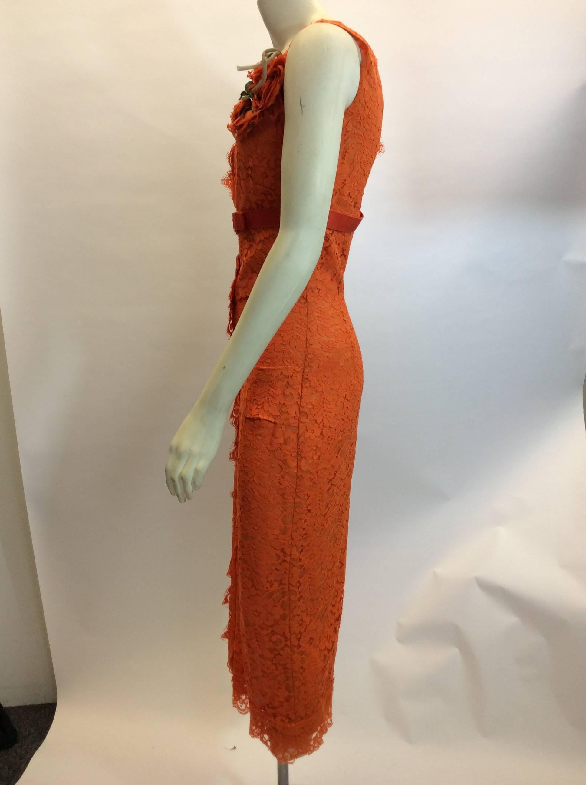 Dolce & Gabanna Lace Orange V Neck Dress 
Rouched down the center of the dress
Flower detail on chest
V neck and V in the back
Fully lined
NWT - Original price $3510
