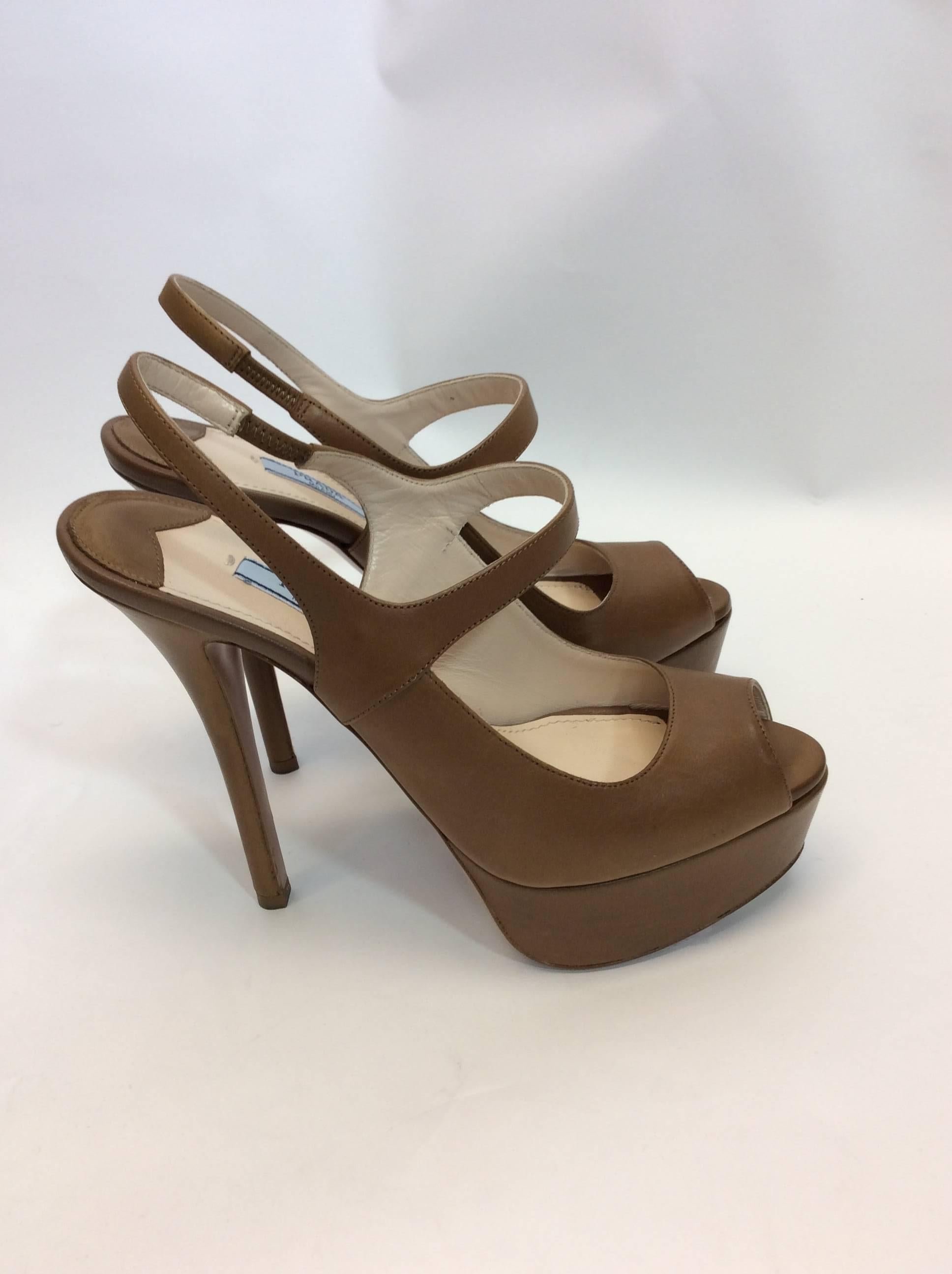 Prada Leather Peep Toe Platform Stiletto
2 inch platform
5.5 inch heel
Peep toe style
Comes with box
$450 
Made in Italy
Size 38.5