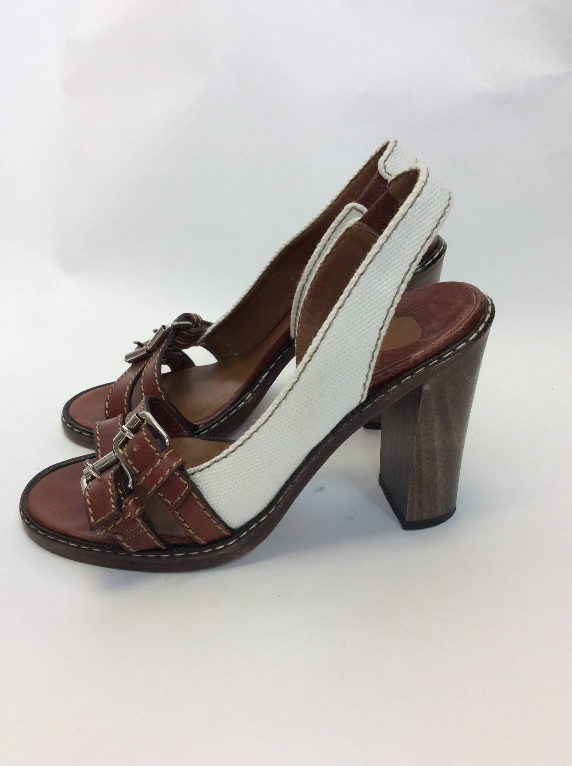 Chloe Leather Buckle Canvas Heels
Leather straps with buckle
canvas cream ankle strap
Wooden heel
Size 38
4 inch heel 
$208
