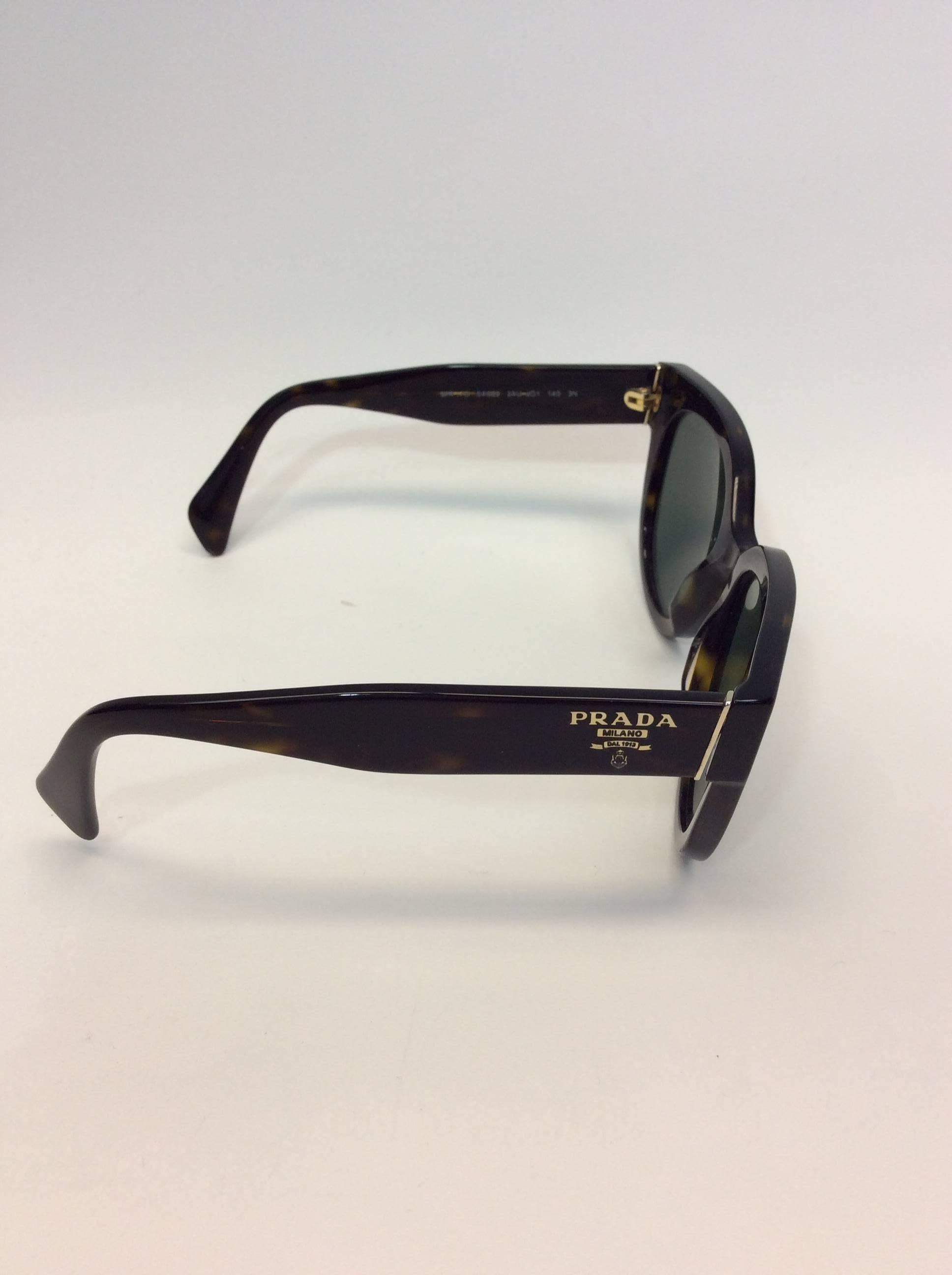 Prada Tortoiseshell Sunglasses
Dark tortoise style color
Embellished with the Prada logo on the temples
Small silver metal triangular detail on the frame corners
Made in Italy
$208
6.25 inches in length by 2.5 inches height
