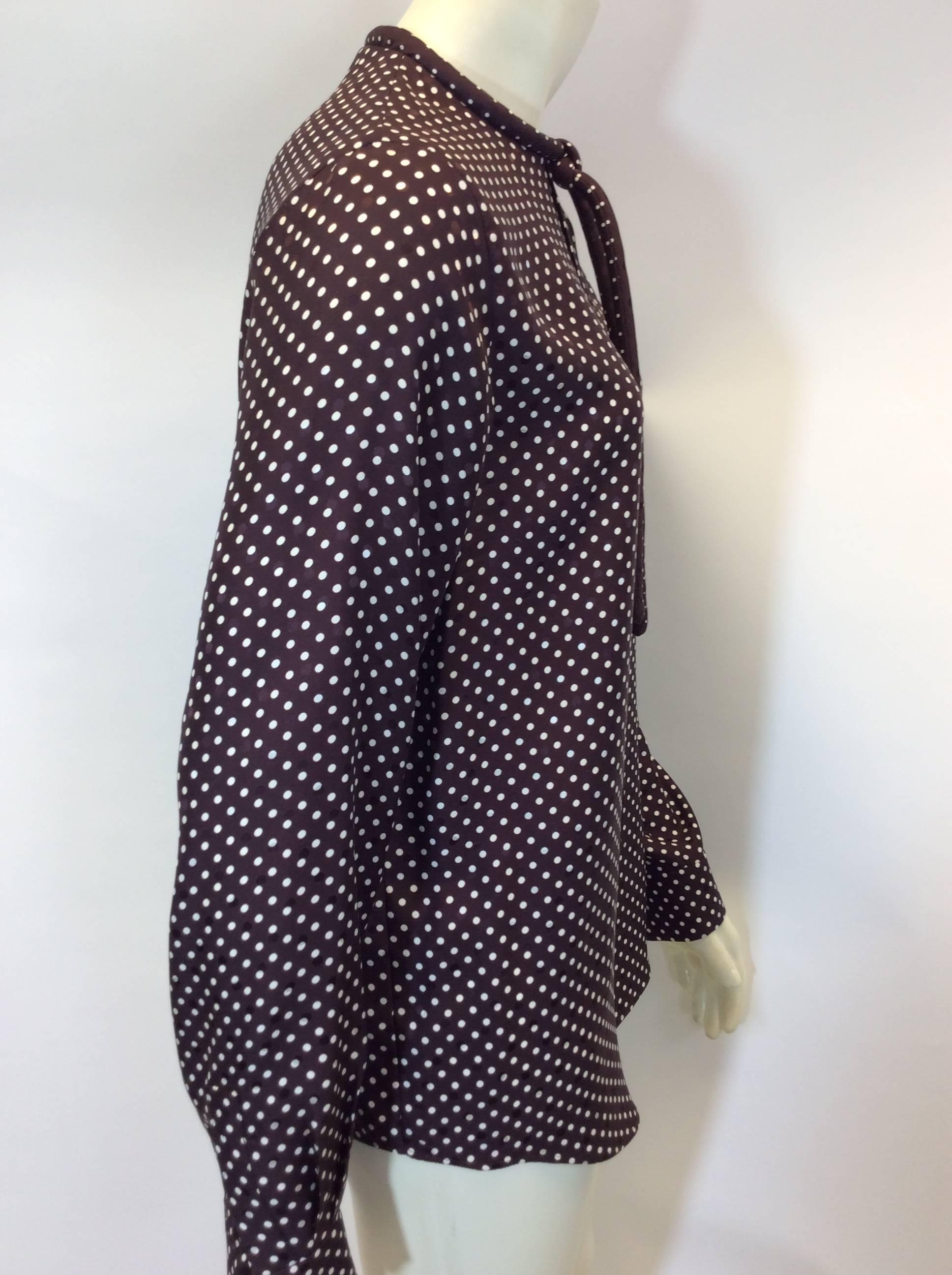 Brown Polka Dot Blouse with Neck Tie
Corded tie detail on front neckline
Button closure on back neckline
One button closure on cuff
Size 38
100% Silk