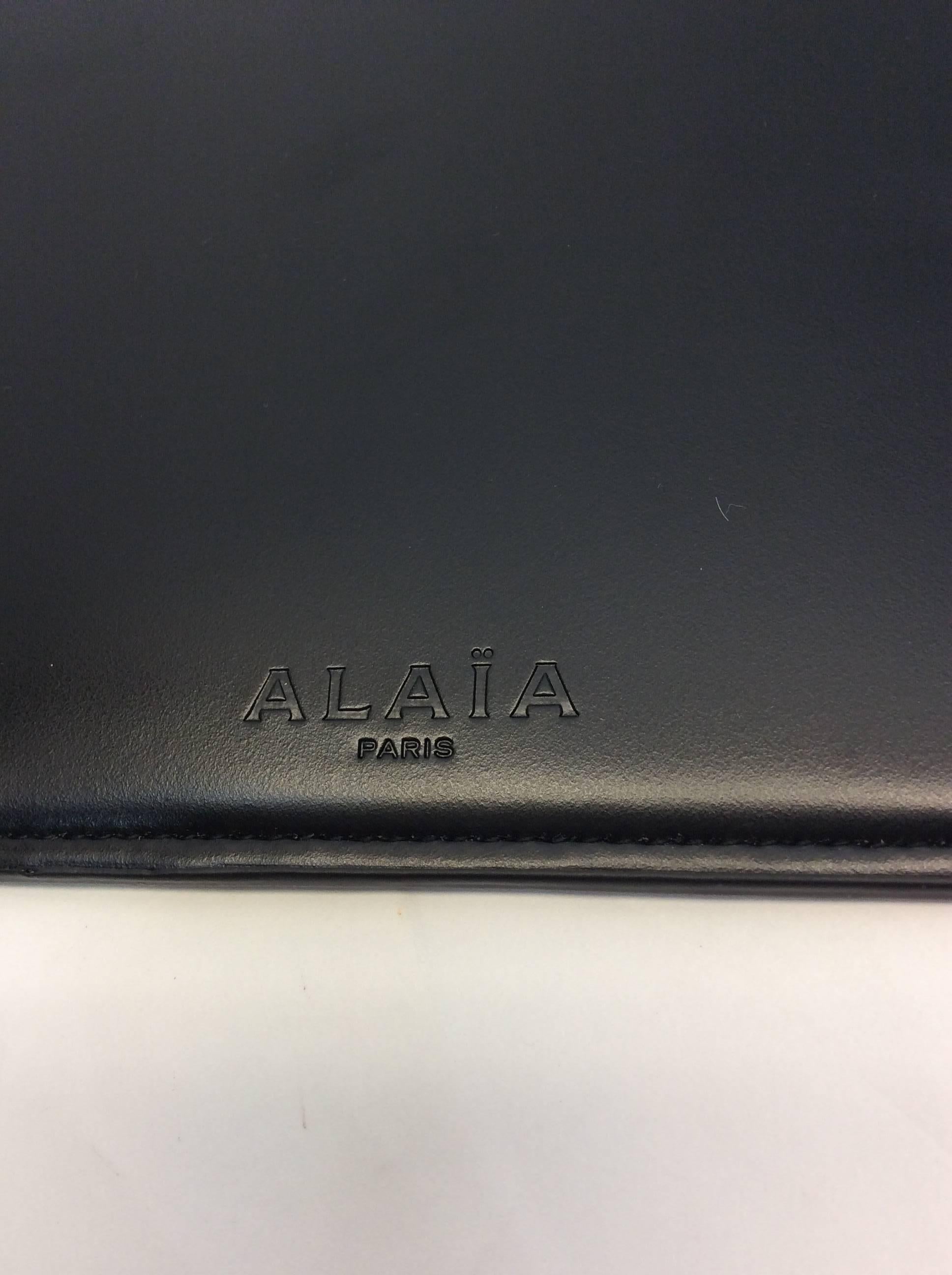 Black Leather Zip Pouch
8 inches long, 5.5 inches wide
Top zipper closure
Alaia logo zipper pull
Leather exterior and lining