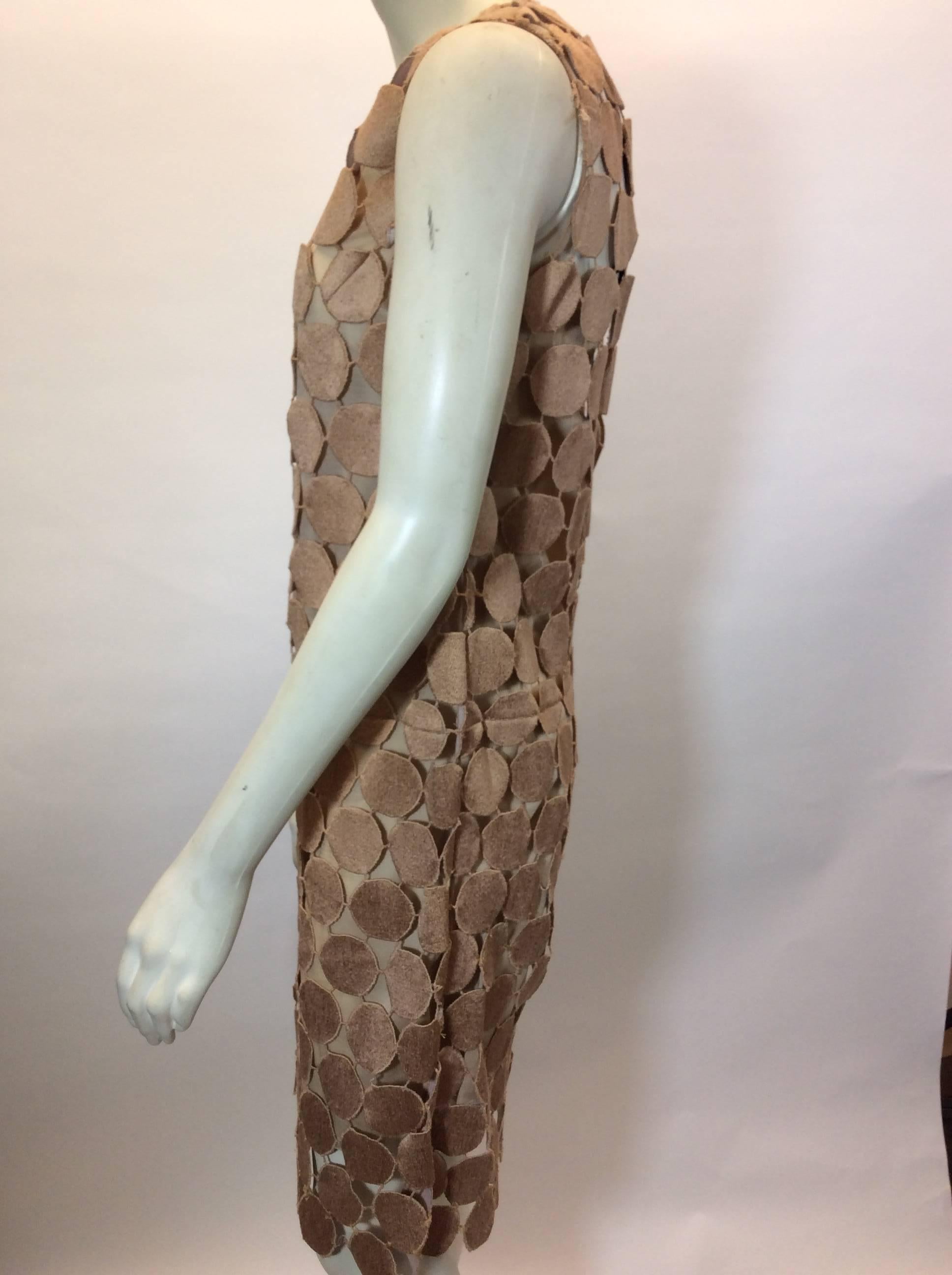 Tan Crocheted Circle Pattern Sheath Dress
Nude lining
Black tie closure on neckline
Sleeveless
Size 40
100% Cotton
