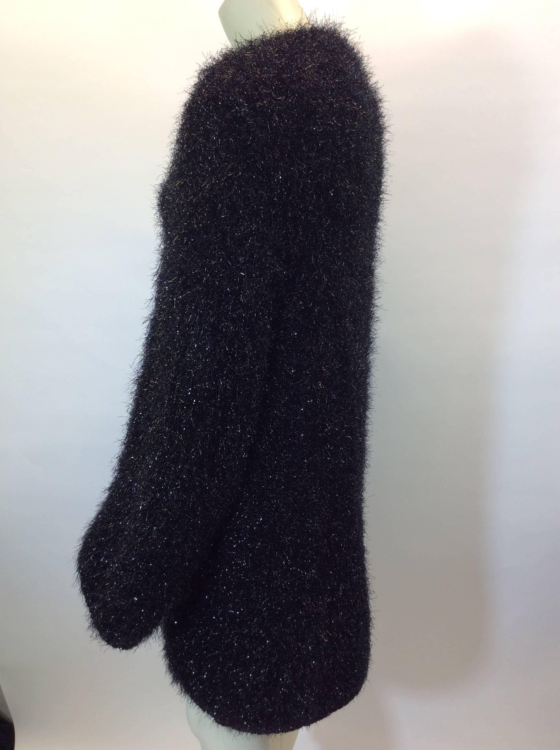 Black Fuzz Coat
3 snap front closure
Features two hip pockets
Fuzzy texture is reflective in different lights
Knee length
Fabric has stretch
Size Medium
85% Polyamide, 10% Wool, 5% Cashmere