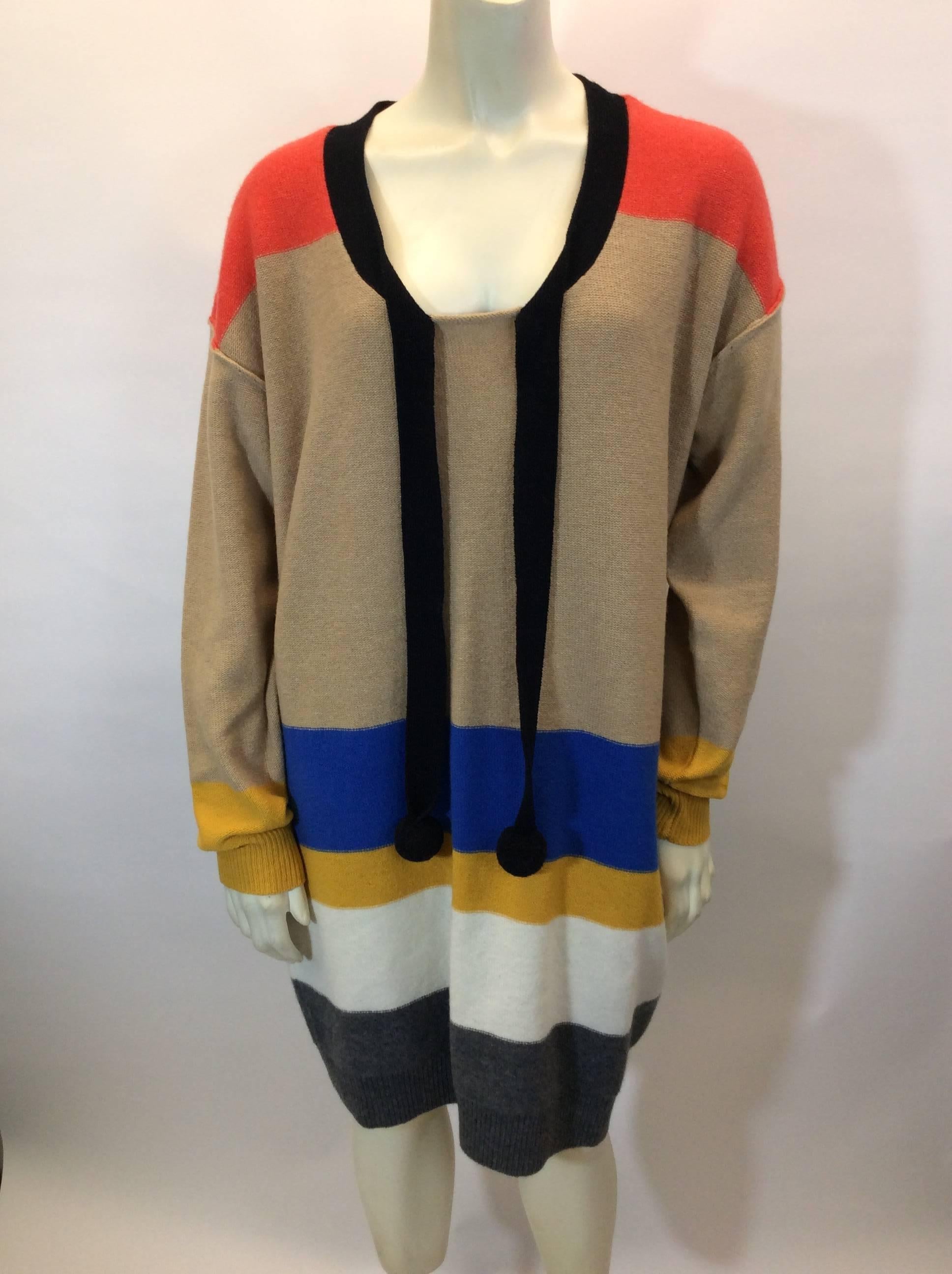 Multicolor Striped Tunic with Pom Pom Neck Tie
Includes two side seam hip pockets
Ribbed cuff and hemline
Adjustable neck tie with pom pom ends
Size 2
100% Wool