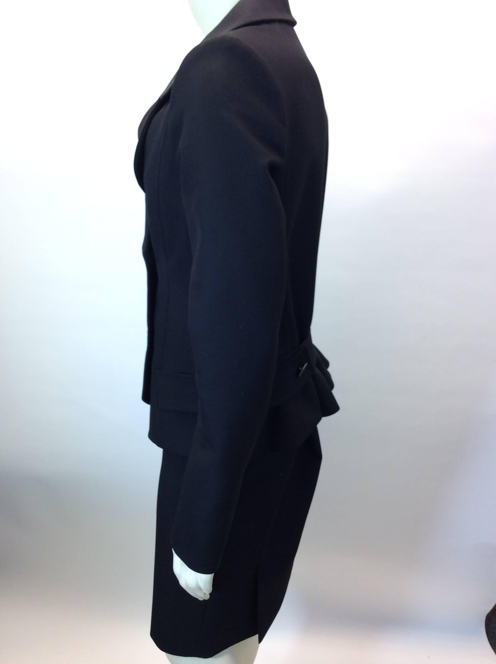 Black Skirt Suit with Peplum Detail
Double breasted blazer with two button closure
Side seam zipper closure on skirt
Blazer features back peplum detail with adjustable belt
Size and fiber content unknown (refer to measurements)
