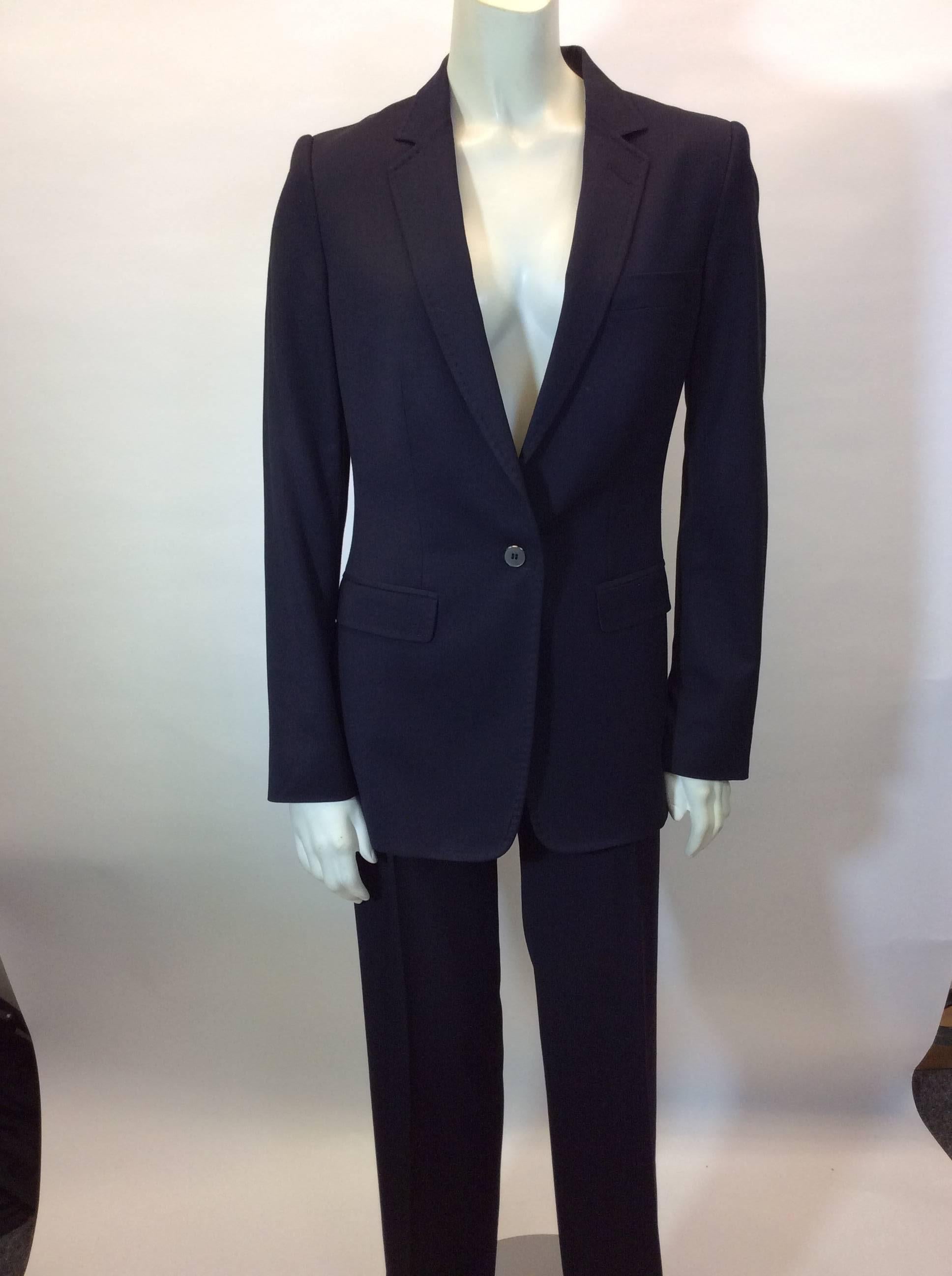 Navy Pantsuit with One Button Blazer
Blazer features two hip pockets and one chest pocket
Two hip pockets in trousers
One button closure on blazer
Full length straight leg trouser
Size 40
62% Rayon, 36% Wool, 2% Spandex