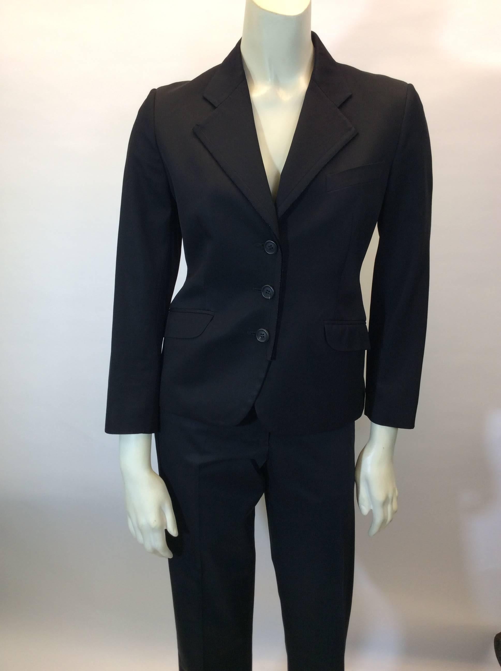 Black Pantsuit with 3 Button Blazer
Unfinished edge details on blazer
Blazer features two hip pockets and one chest pocket
Single breasted
Full length straight leg trouser
Size 42
97% Cotton, 3% Other fibers