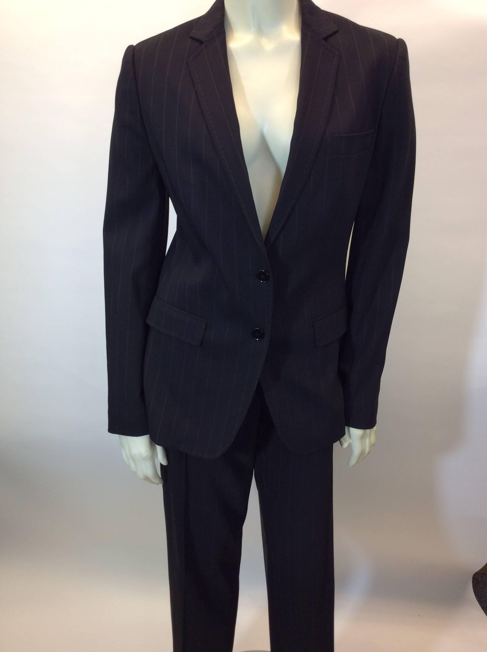 Black Pantsuit with Red Toned Pinstripes
Two button front closure on blazer
Blazer features two hip pockets and one chest pocket
Two hip pockets in pants
Full length straight leg trouser with cuff
Size 40
57% Wool, 40% Rayon, 1% Elastic, 2% Other