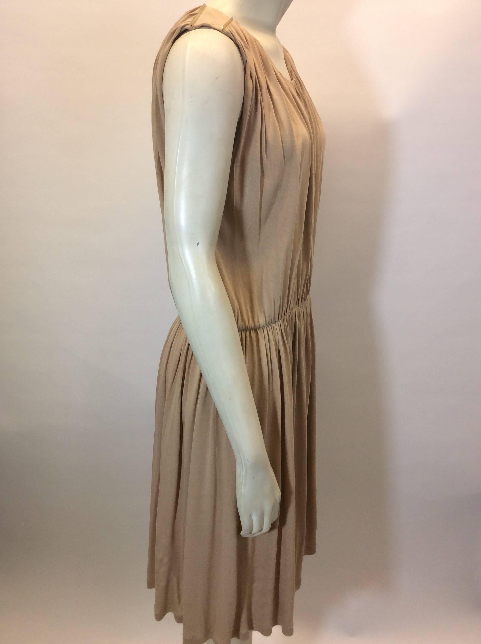 Taupe Longline Romper with Open Back
Features gold stripe detail on shoulder
Ruched design with elastic waist
Size Small
100% Viscose